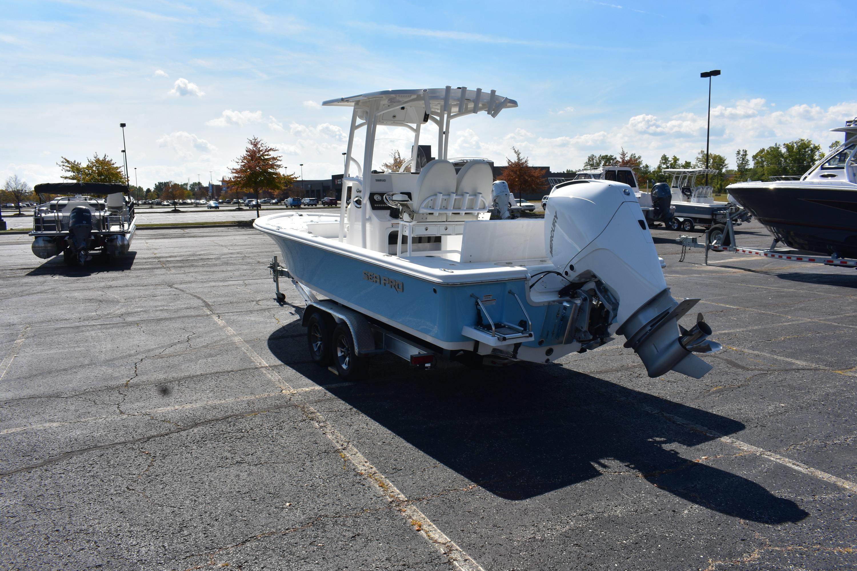 2025 Sea Pro 230 Bay boat in parking lot, rear view with outboard motor.