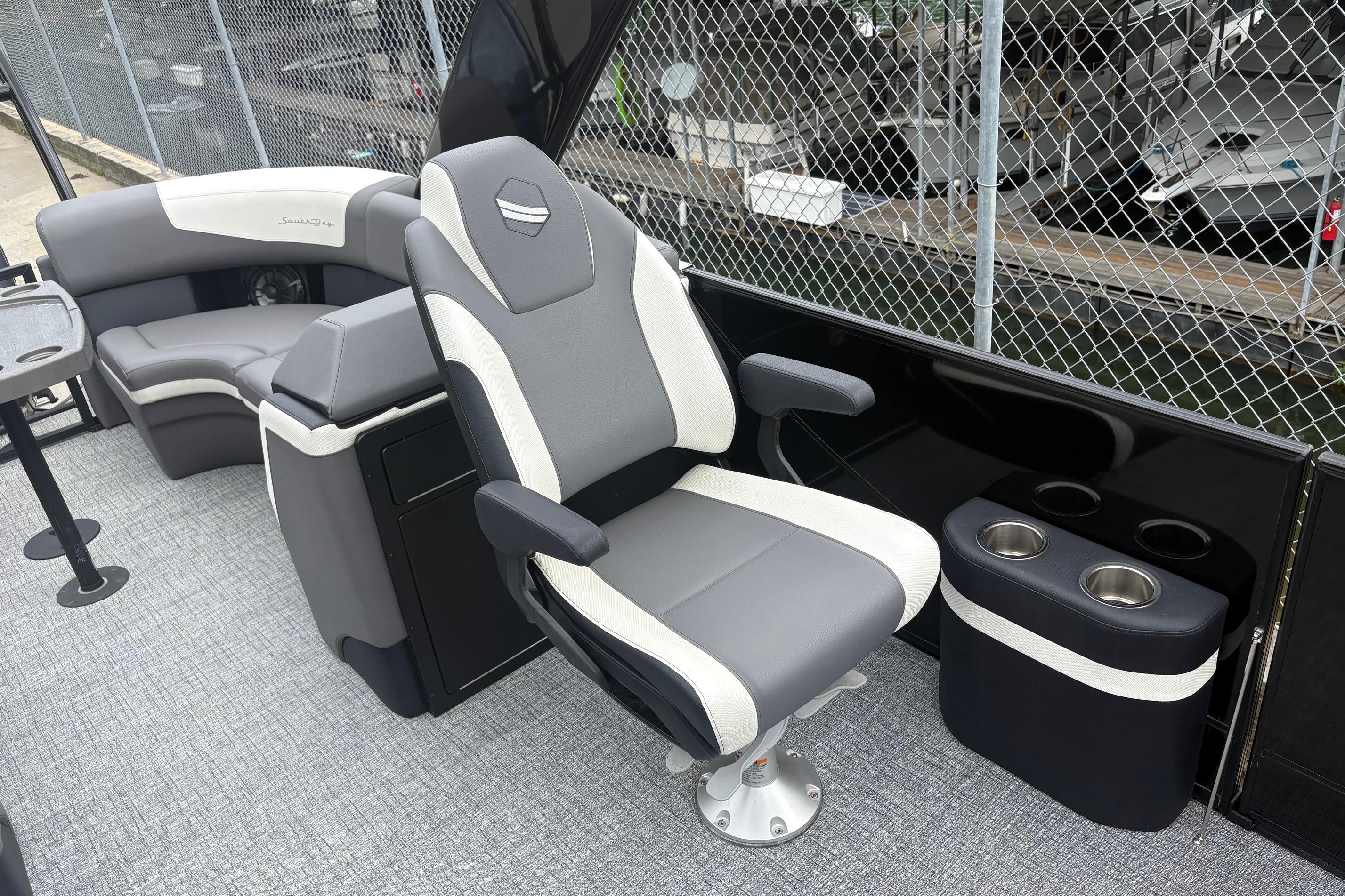Luxurious seating on 2023 South Bay 525 RS 3.0 Arch boat, featuring modern design and cup holders.