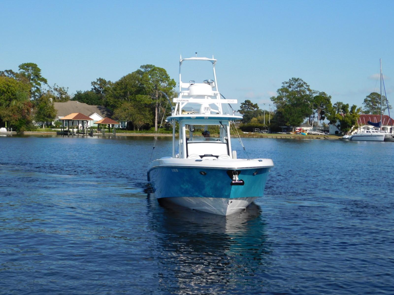 2016 Everglades 355 Center Console boat on a serene lake.
