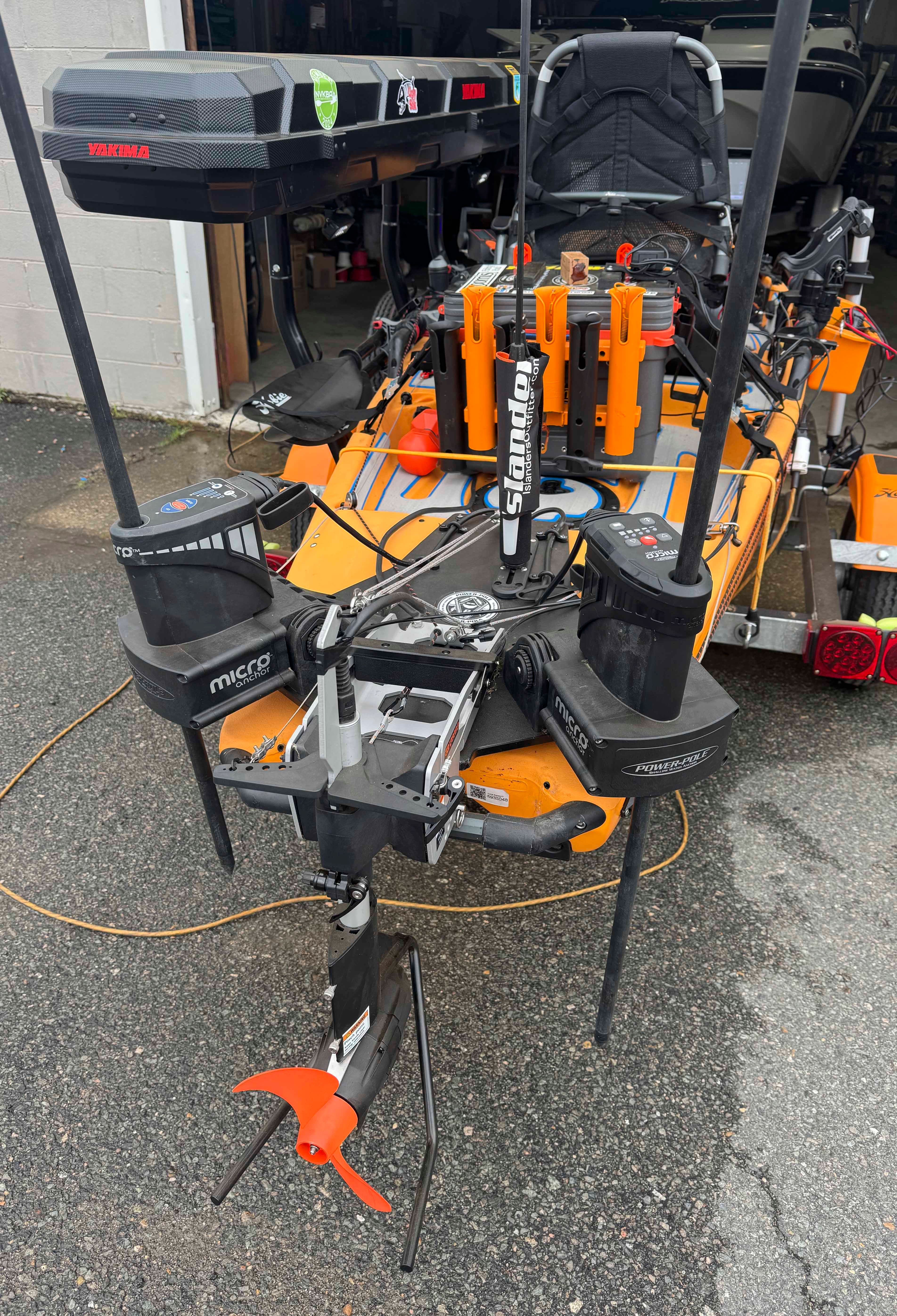 An orange Hobie 14 Pro Angler kayak with fishing gear and equipment on a trailer.