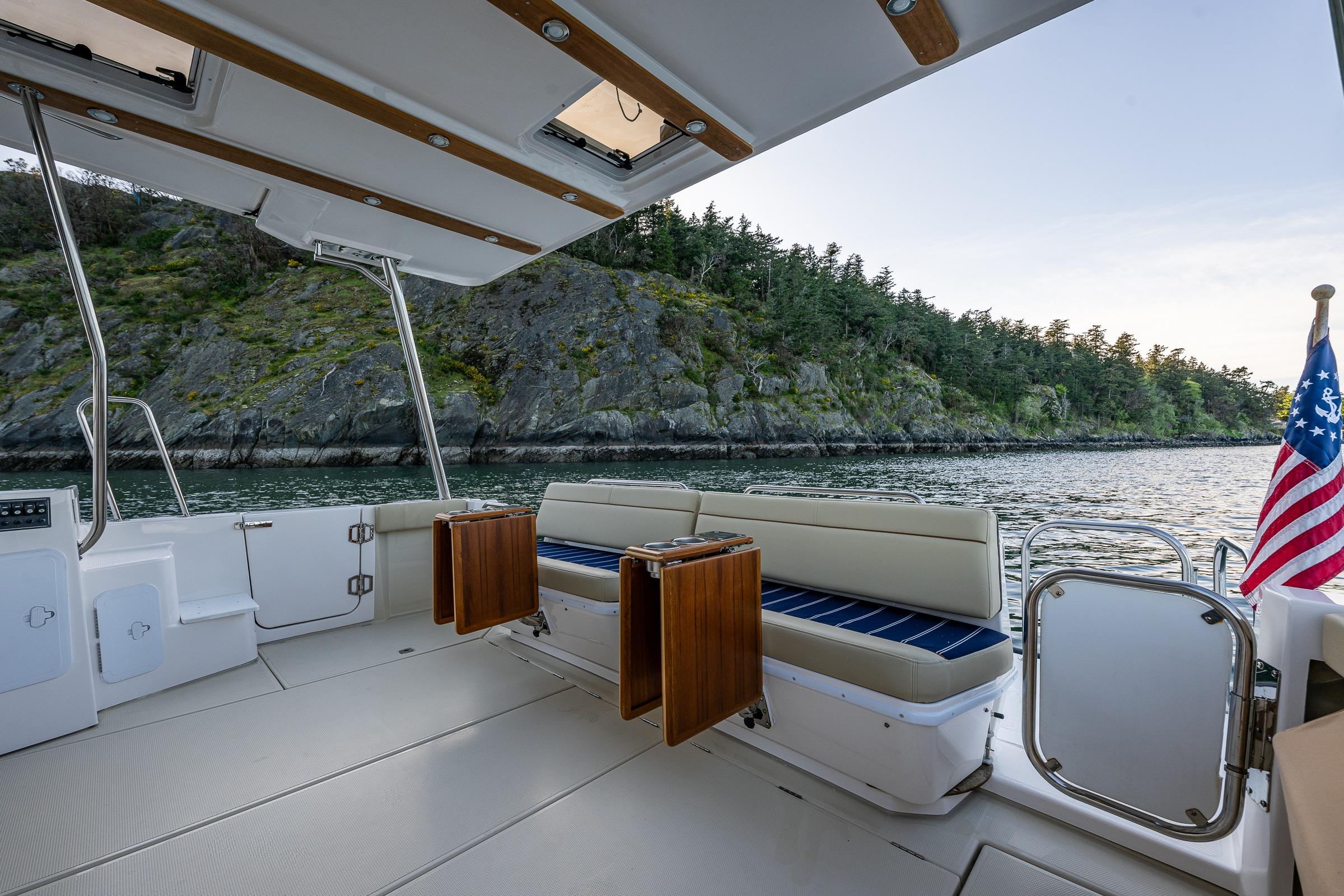 2020 Ranger Tugs R-41 CB boat interior with scenic water and rocky shoreline view.