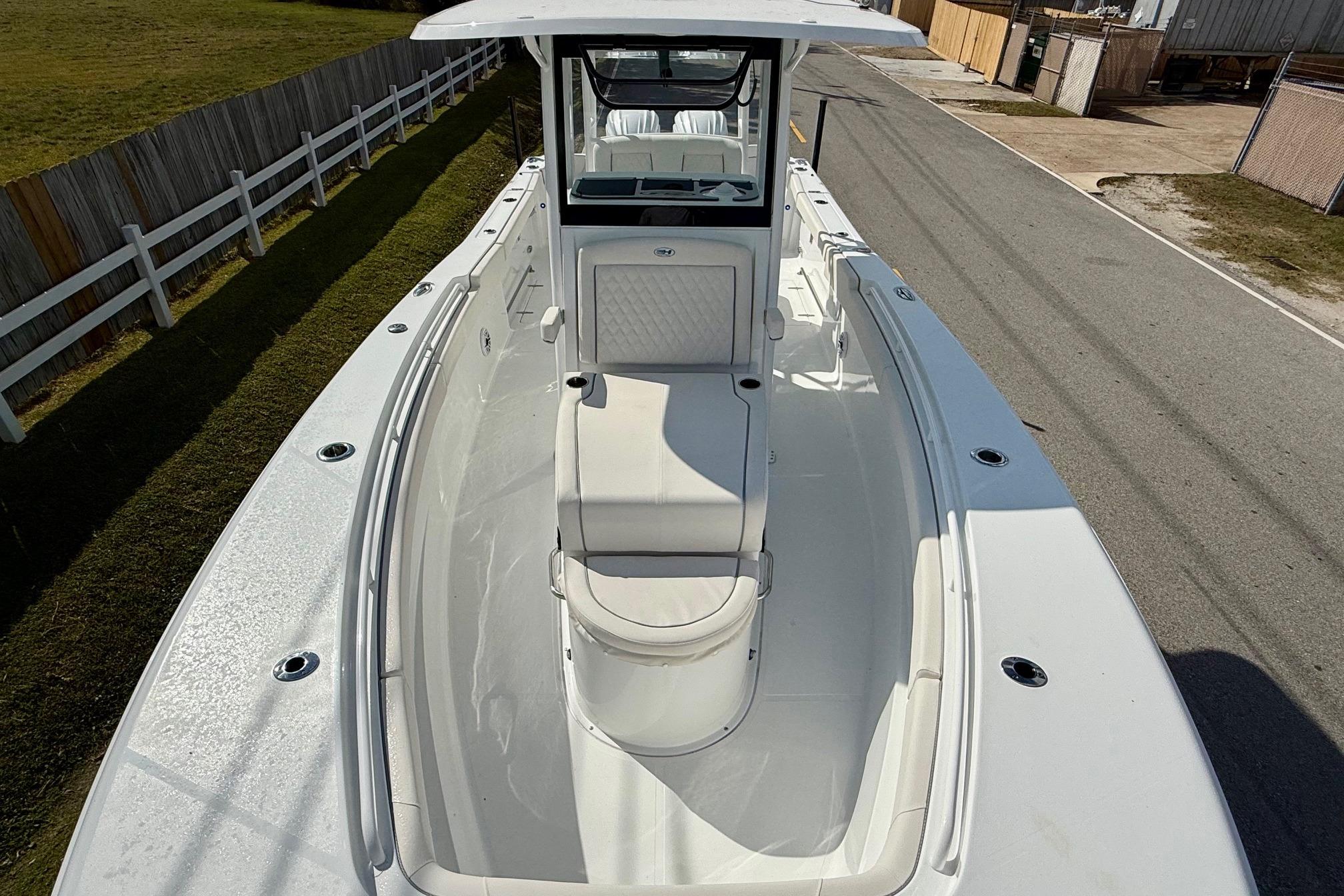 2026 Sea Hunt Ultra 285 Coffin Box boat, white exterior, spacious deck, parked on a road.