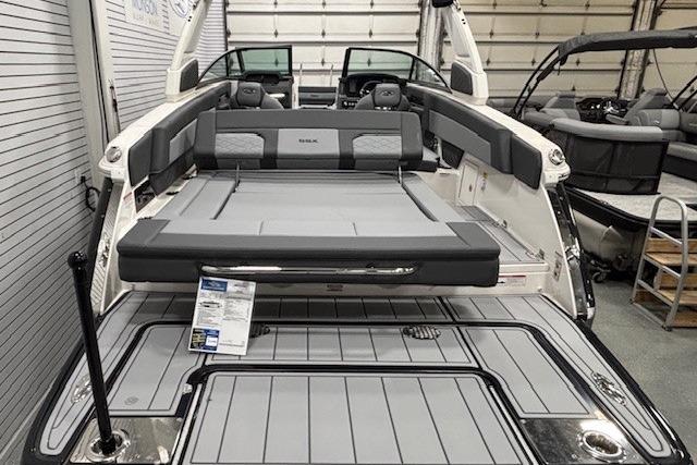 2026 Chaparral SSX 8 boat interior with sleek seating and modern design in a showroom.