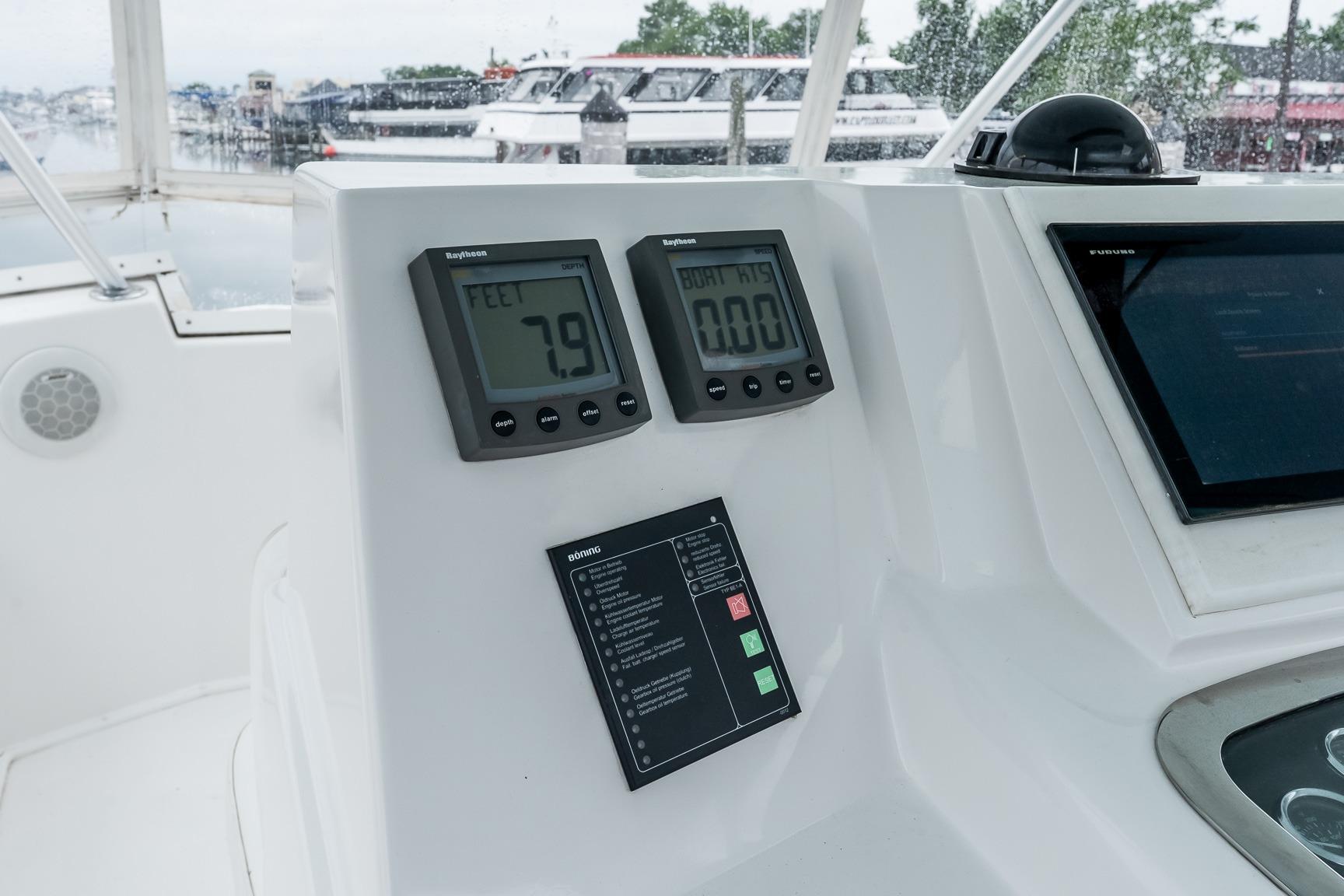 Control panel of a 2000 Viking 50' Convertible yacht with digital displays and navigation equipment.
