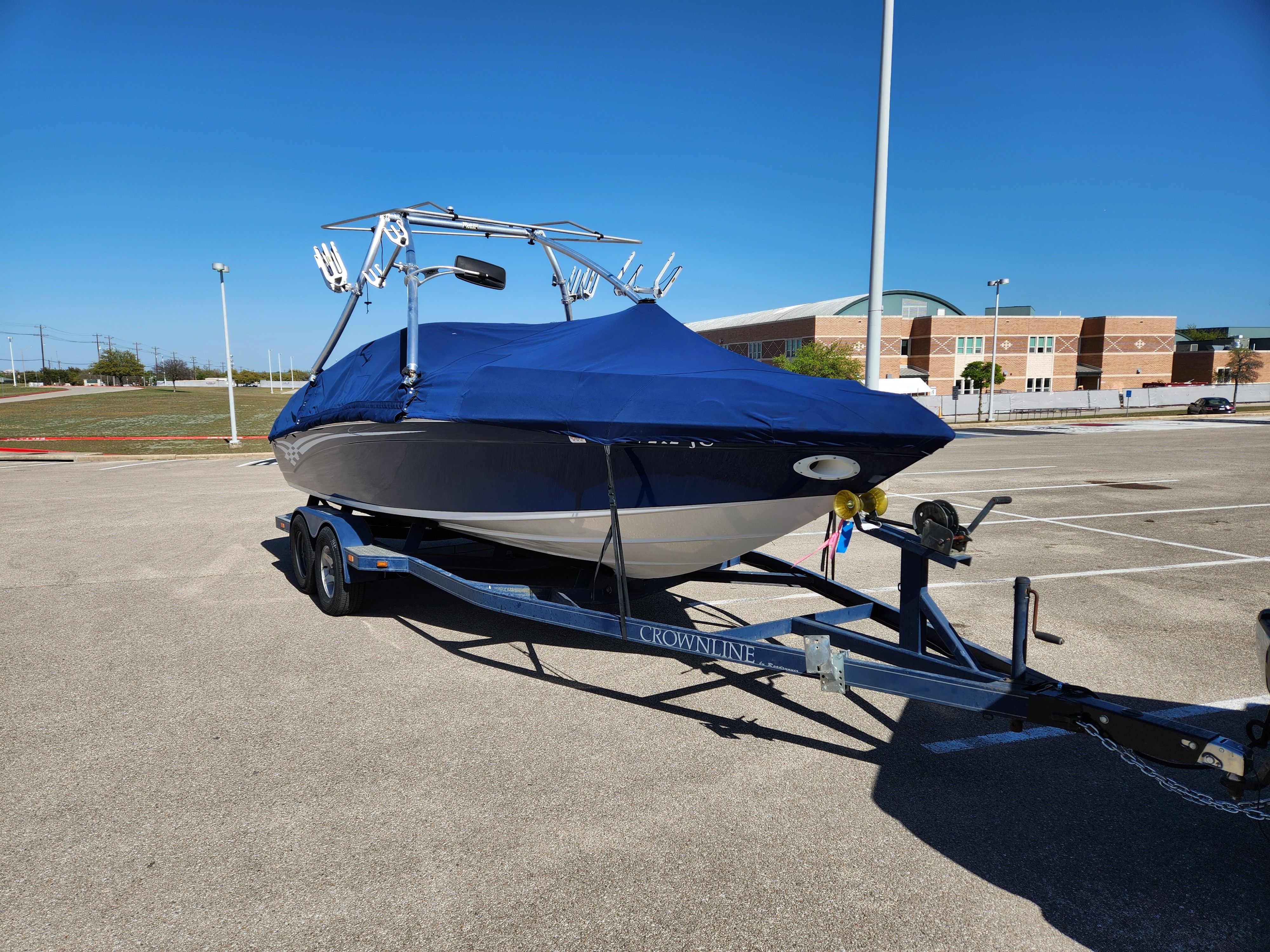 2003 Crownline 225 BR boat on trailer parked outdoors.