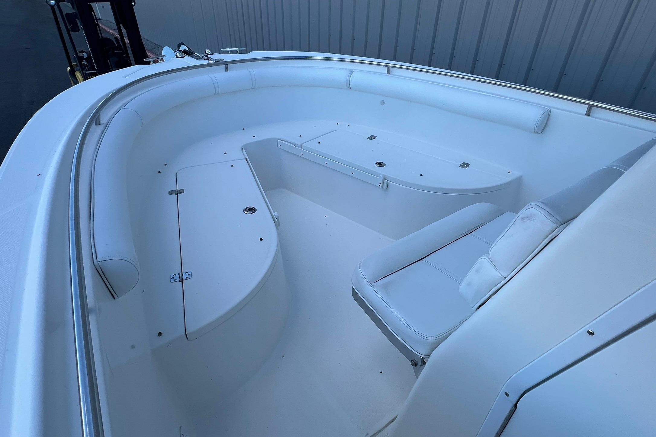 2006 Edgewater 245CC boat interior with white seating and storage compartments.
