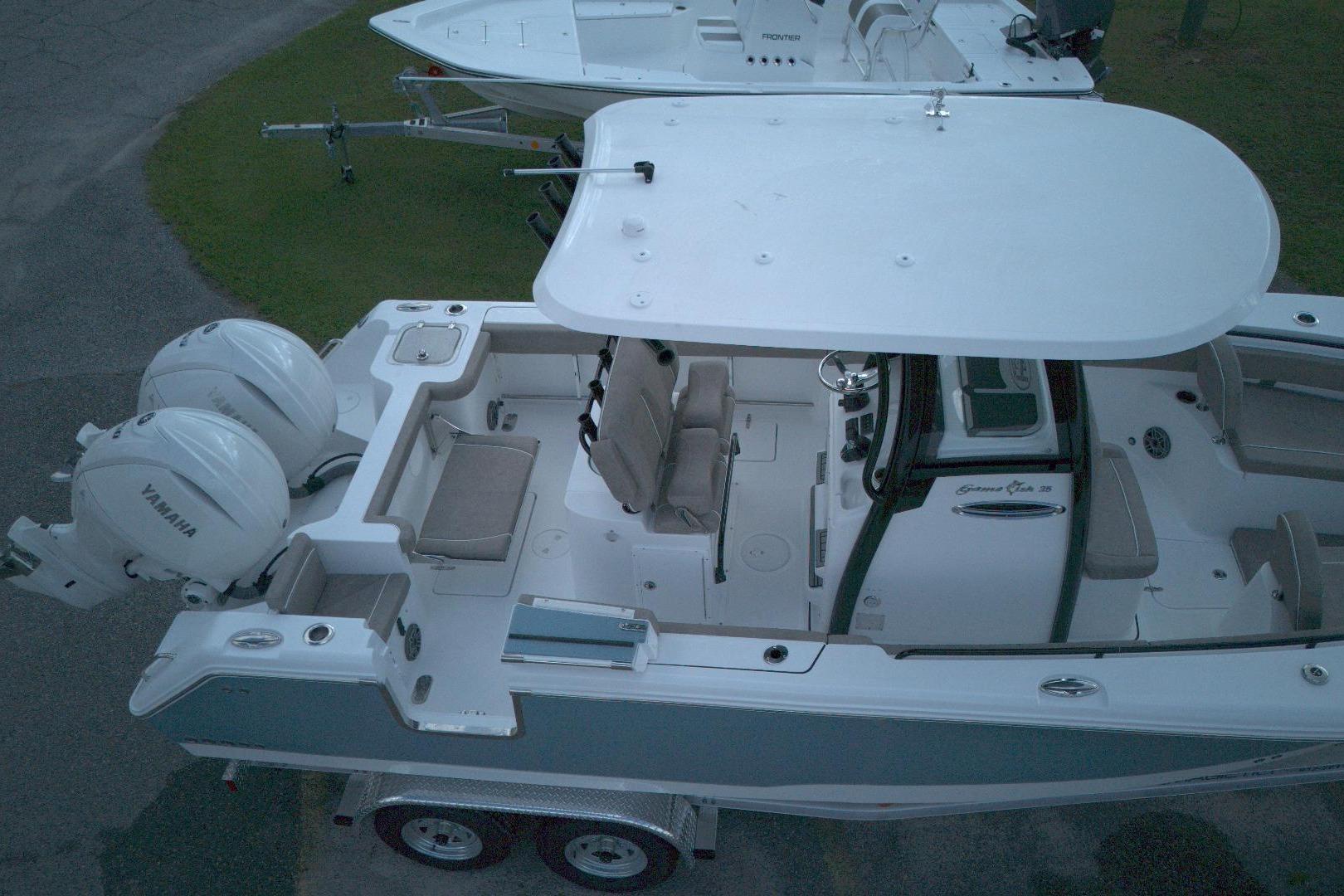2026 Sea Hunt Gamefish 25 boat with dual Yamaha engines, aerial view.