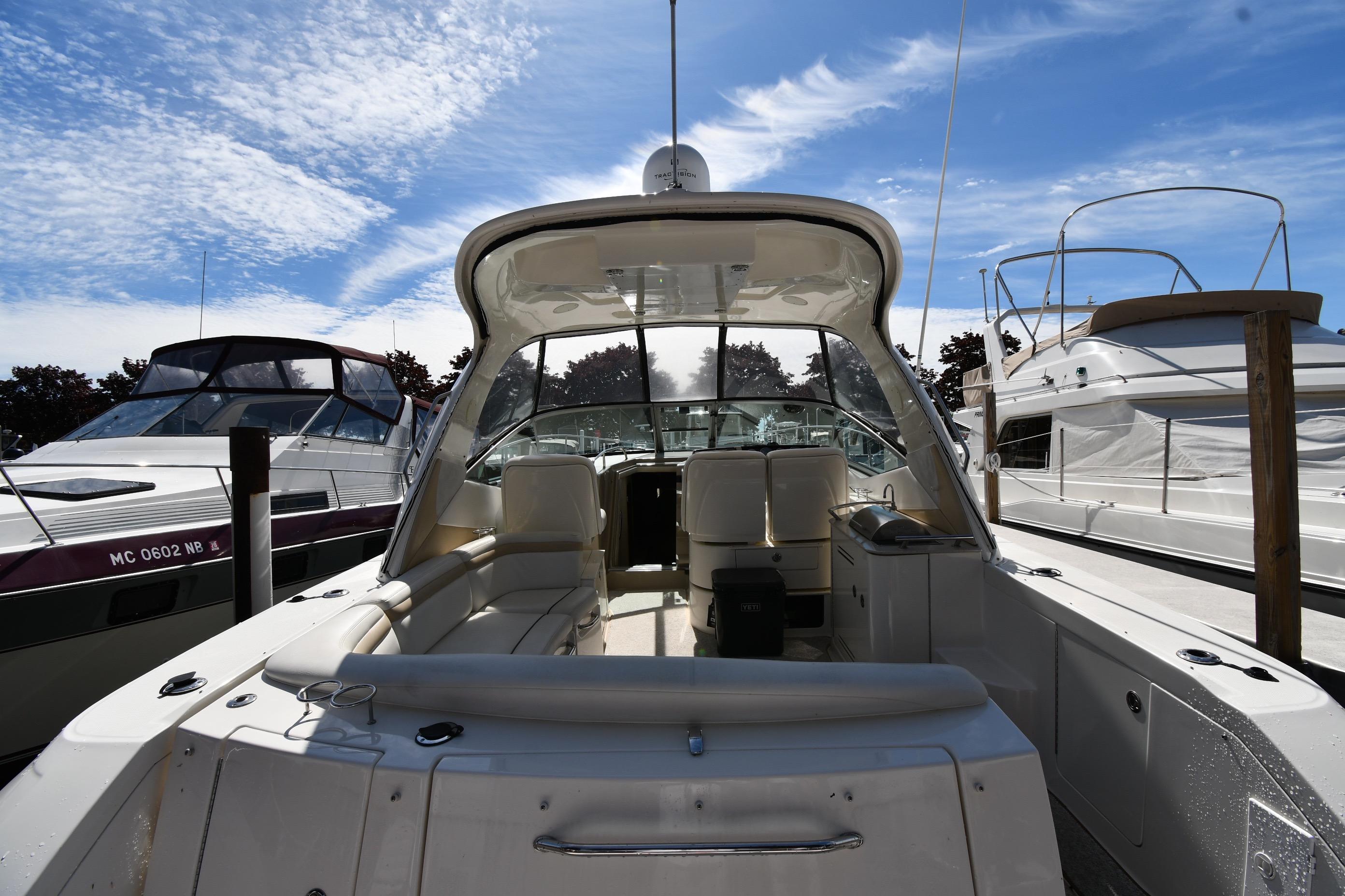 2008 Sea Ray Sundancer 350 yacht docked under a clear blue sky.