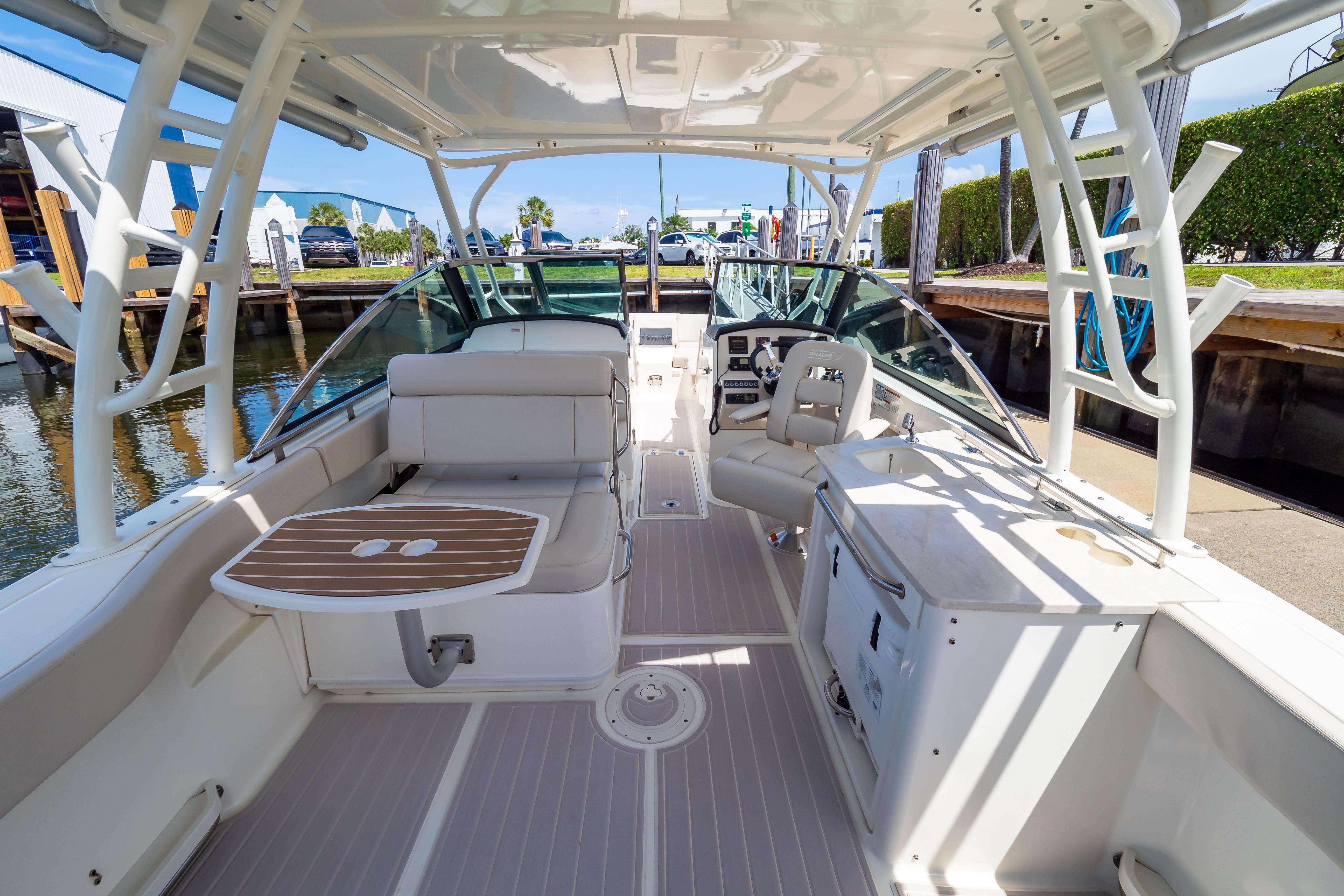 2019 Boston Whaler 270 Vantage boat interior with seating, helm, and table.