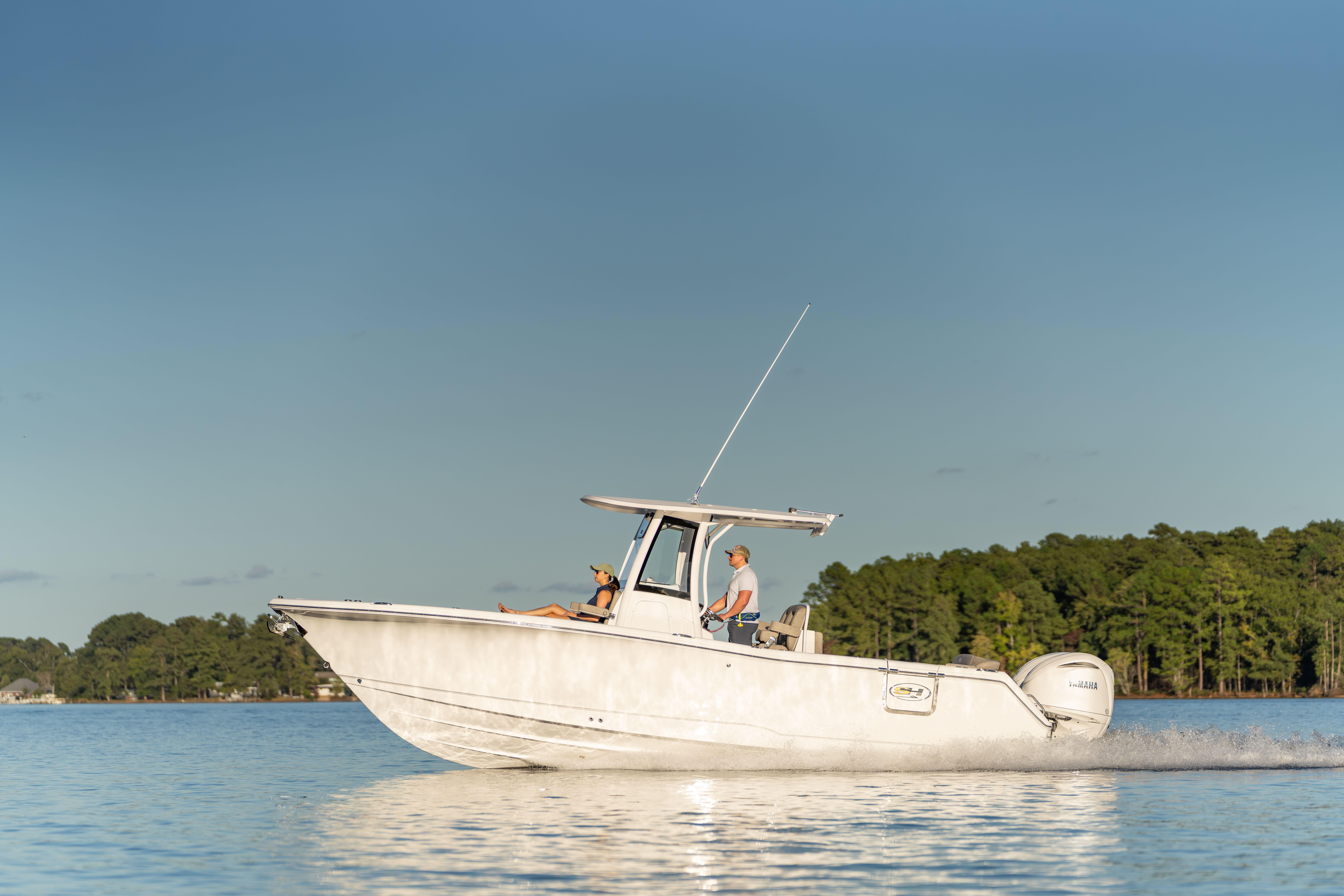 2026 Sea Hunt Ultra 275 Coffin Box boat cruising on a calm lake.