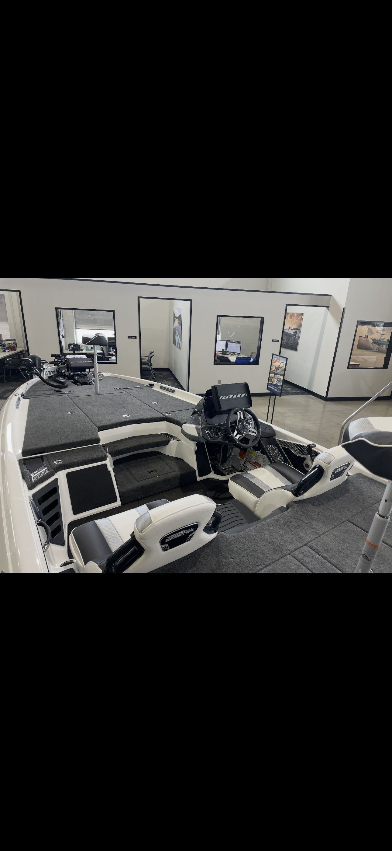 Interior view of a modern boat with steering console and seating.