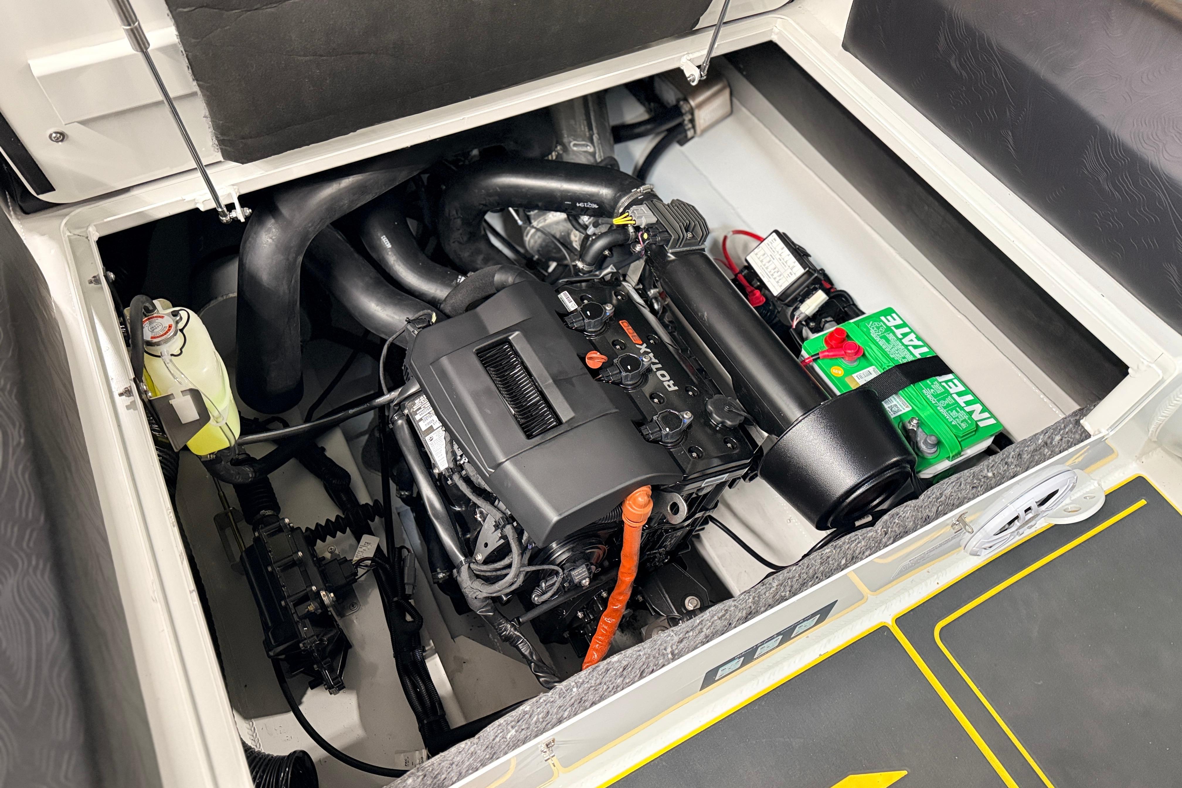 Engine compartment of 2026 Highfield VELOX 560 boat, showcasing motor and battery setup.