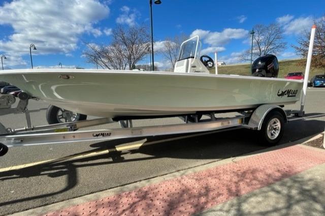 2026 Mako 18 Pro Skiff boat on trailer under blue sky.