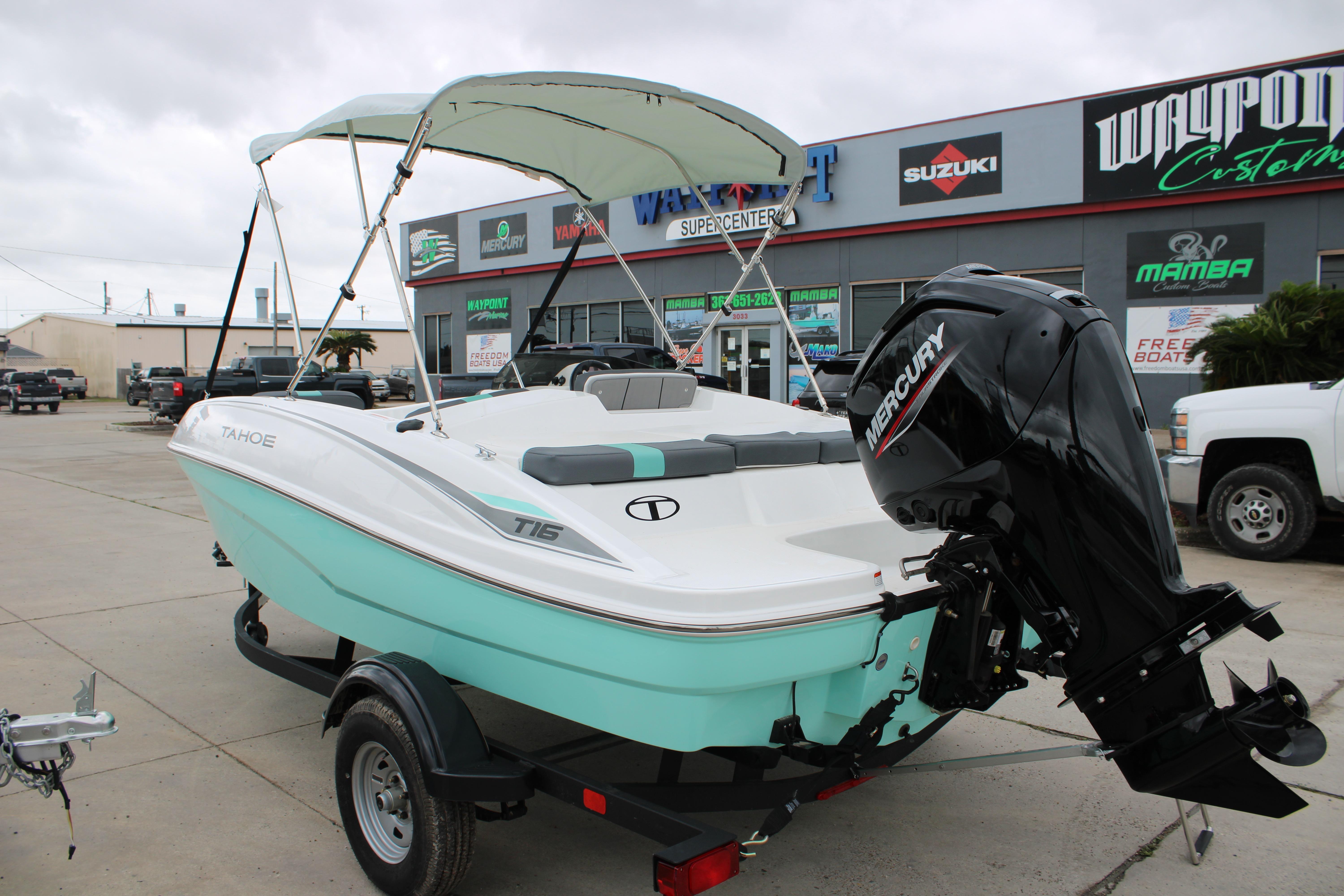 2026 Tahoe T16 boat with Mercury engine on trailer at dealership.