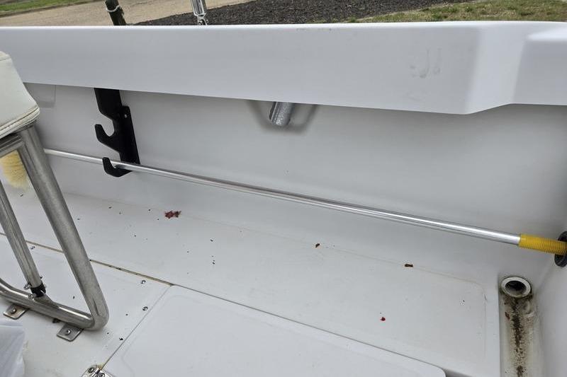 Interior view of a 1996 Boston Whaler Outrage 17 boat, showcasing seating and rod holder.
