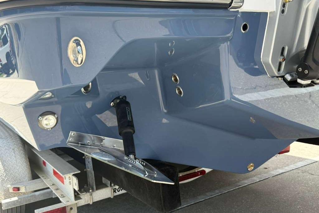 Rear view of a 2026 Monterey Elite 30 OB boat on a trailer.