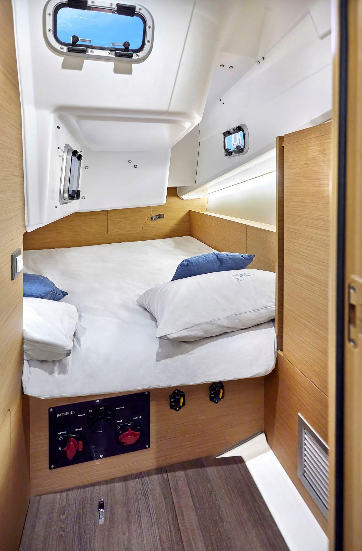 Cozy cabin interior of 2023 Jeanneau Sun Odyssey 380 sailboat with modern design.
