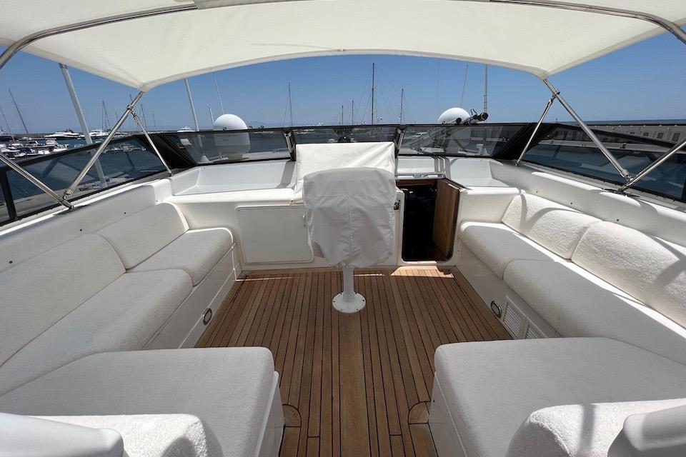 Luxurious 1984 W.A. Souter & Sons 34 yacht interior with white seating and wooden deck.