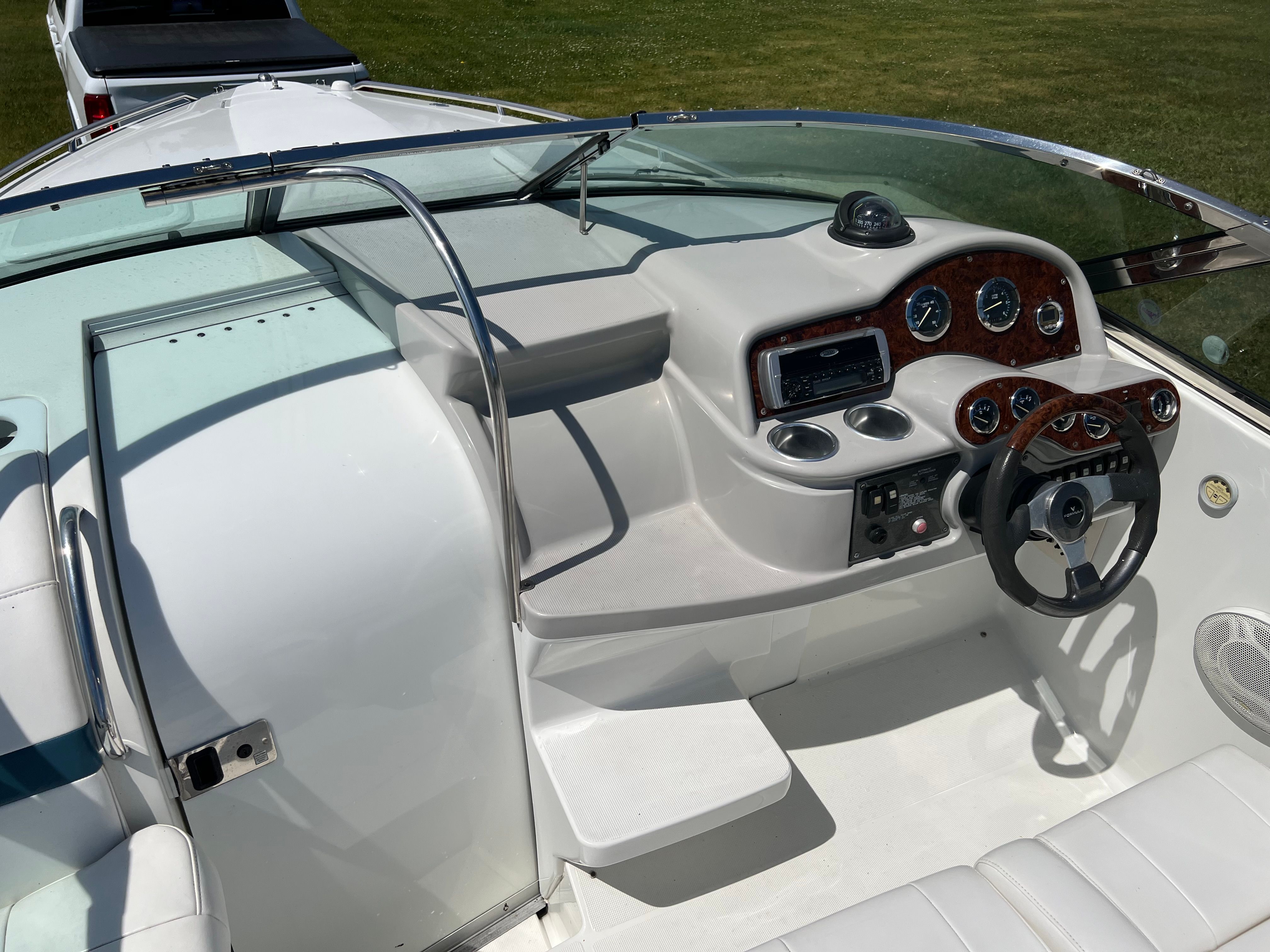 The image shows the cockpit of a 2005 Formula 260 Sun Sport with a sleek dashboard and steering wheel.