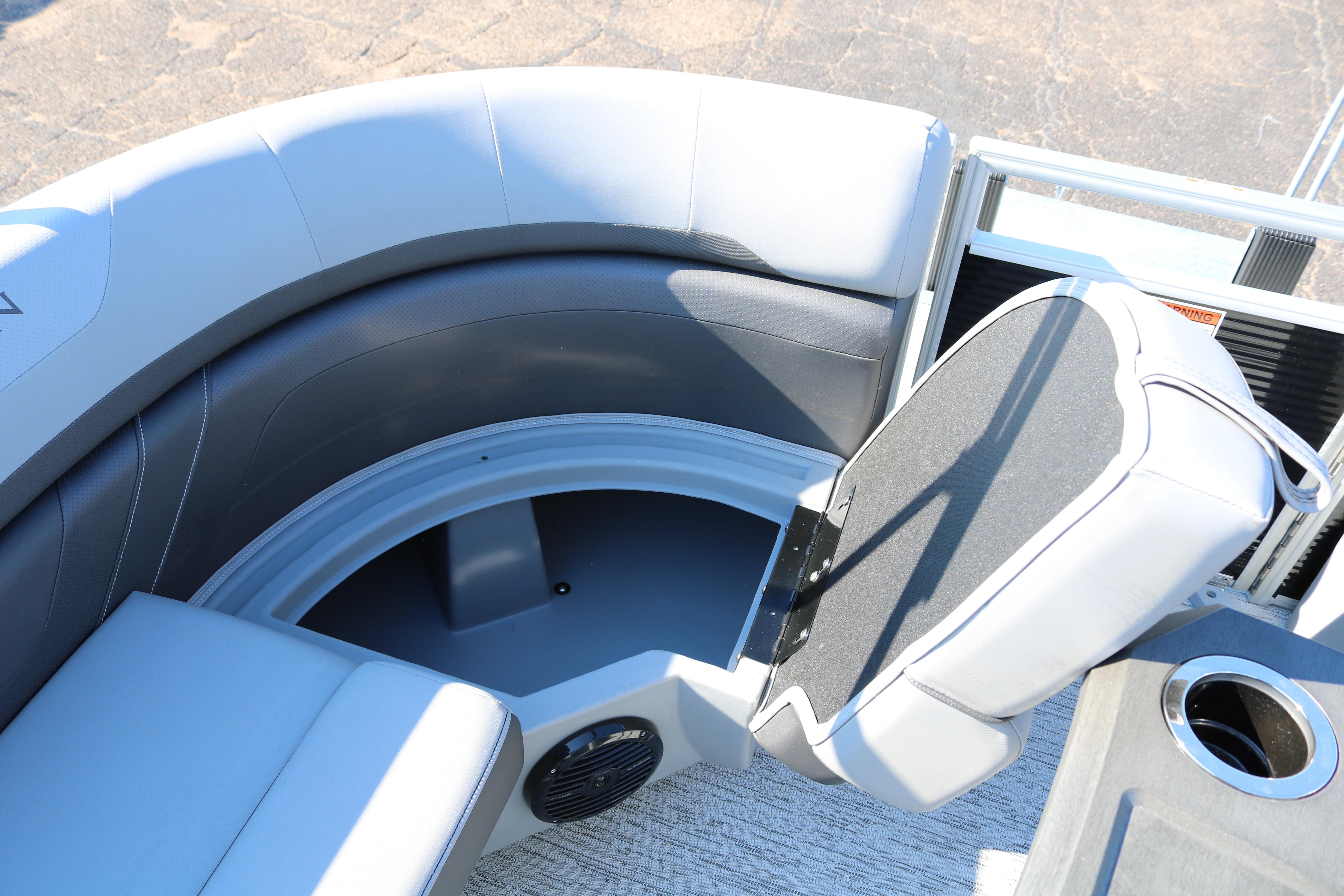 2026 Bennington 22SX Stern Radius boat seating with storage compartment and cup holder.