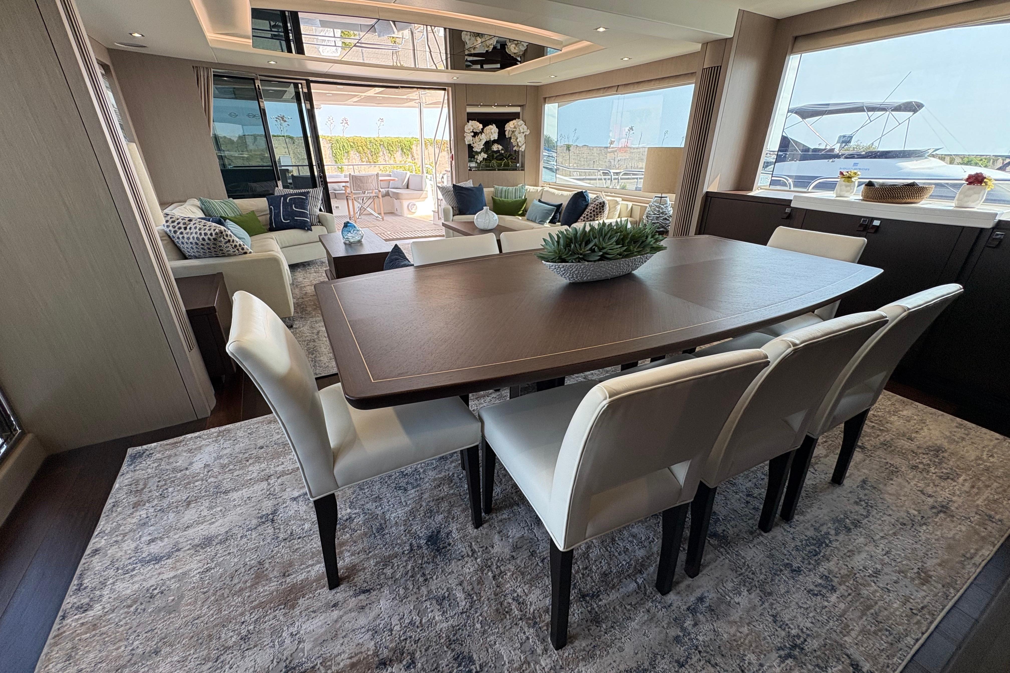 Luxurious interior of 2018 Sunseeker 86 Yacht with elegant dining area and plush seating.