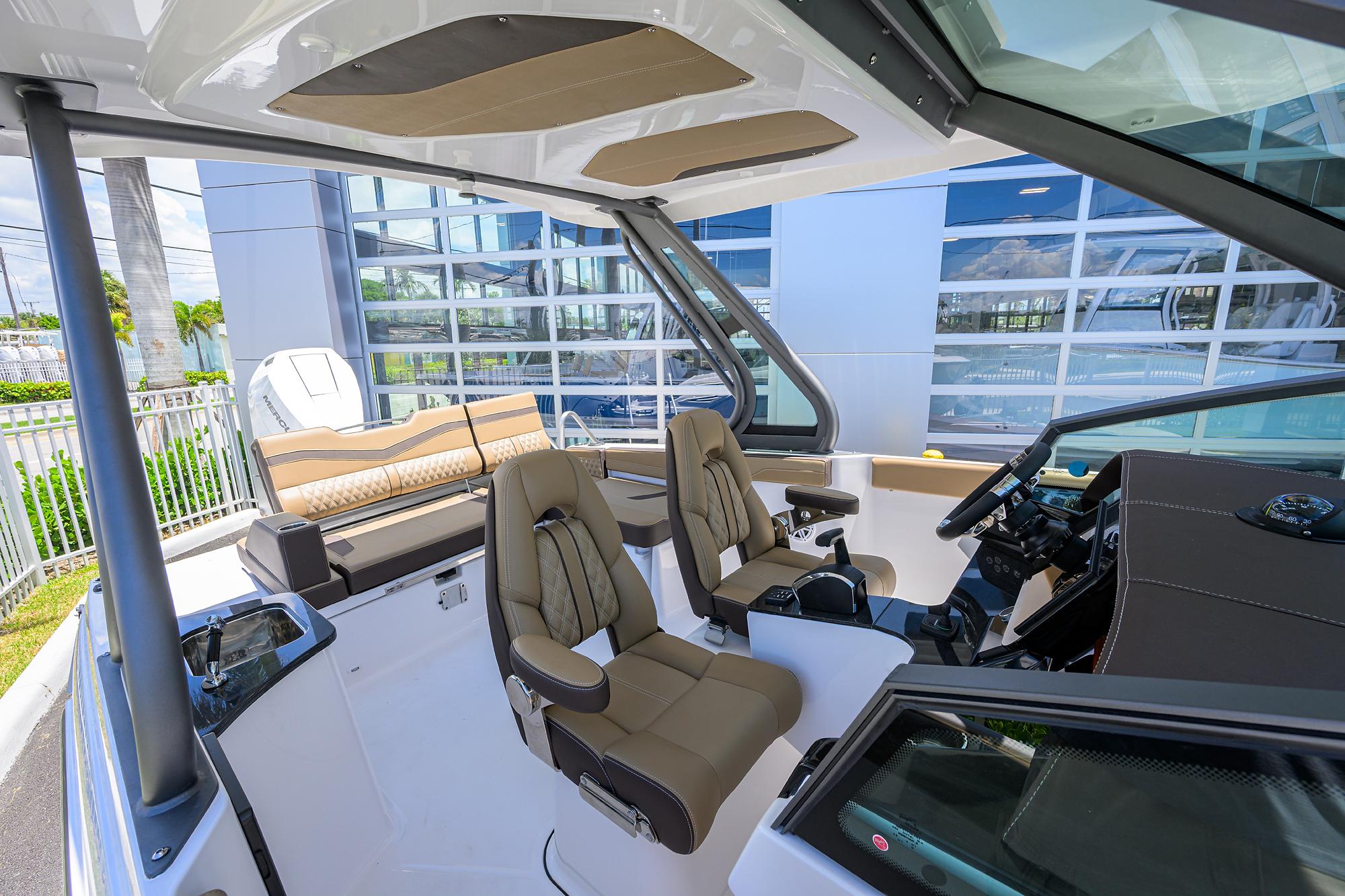 Interior of 2026 Monterey Elite 27 OB boat with modern seating and controls.