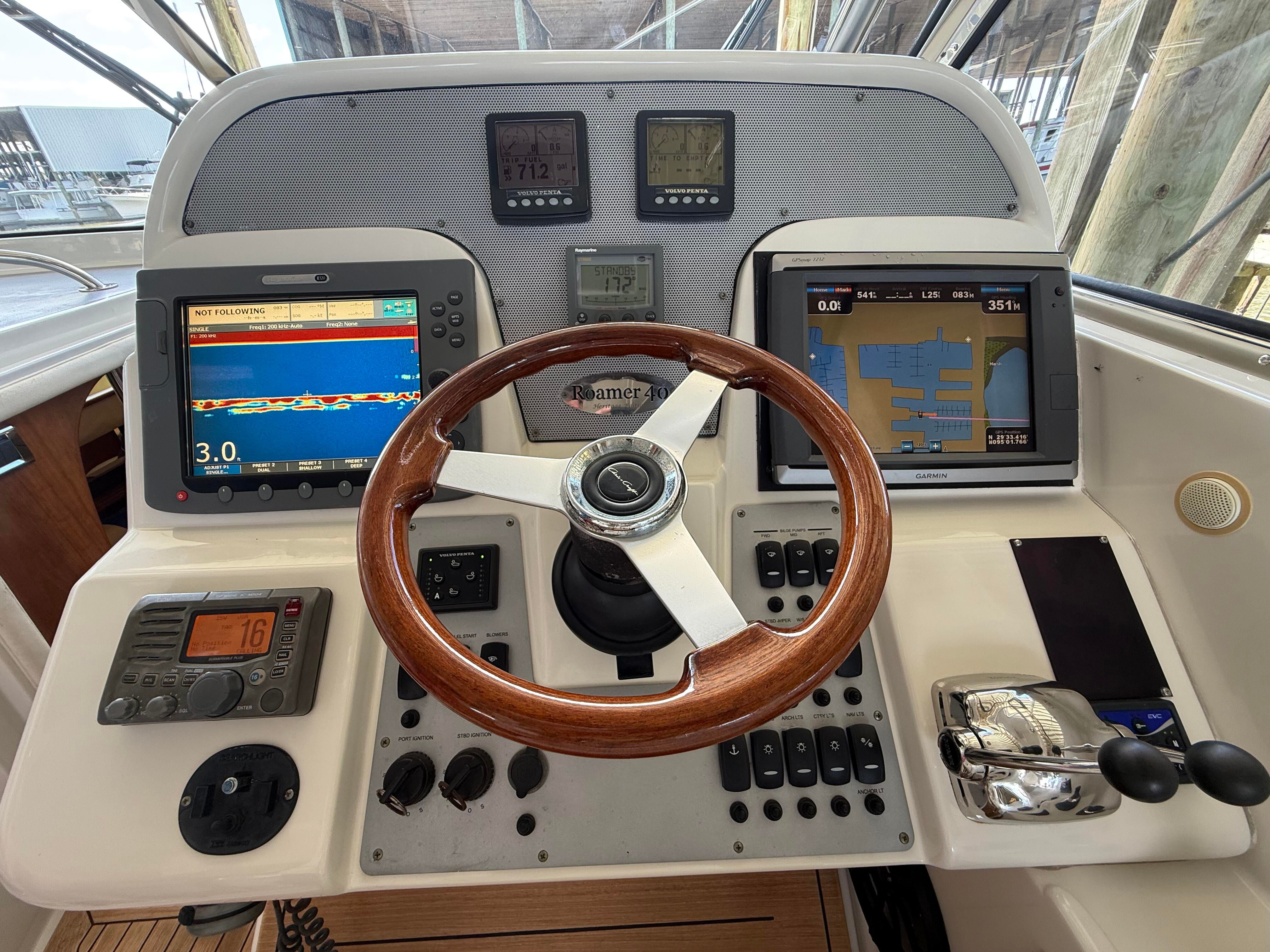 Helm of the 2007 Chris-Craft Roamer 40 with wooden steering wheel and modern instruments.