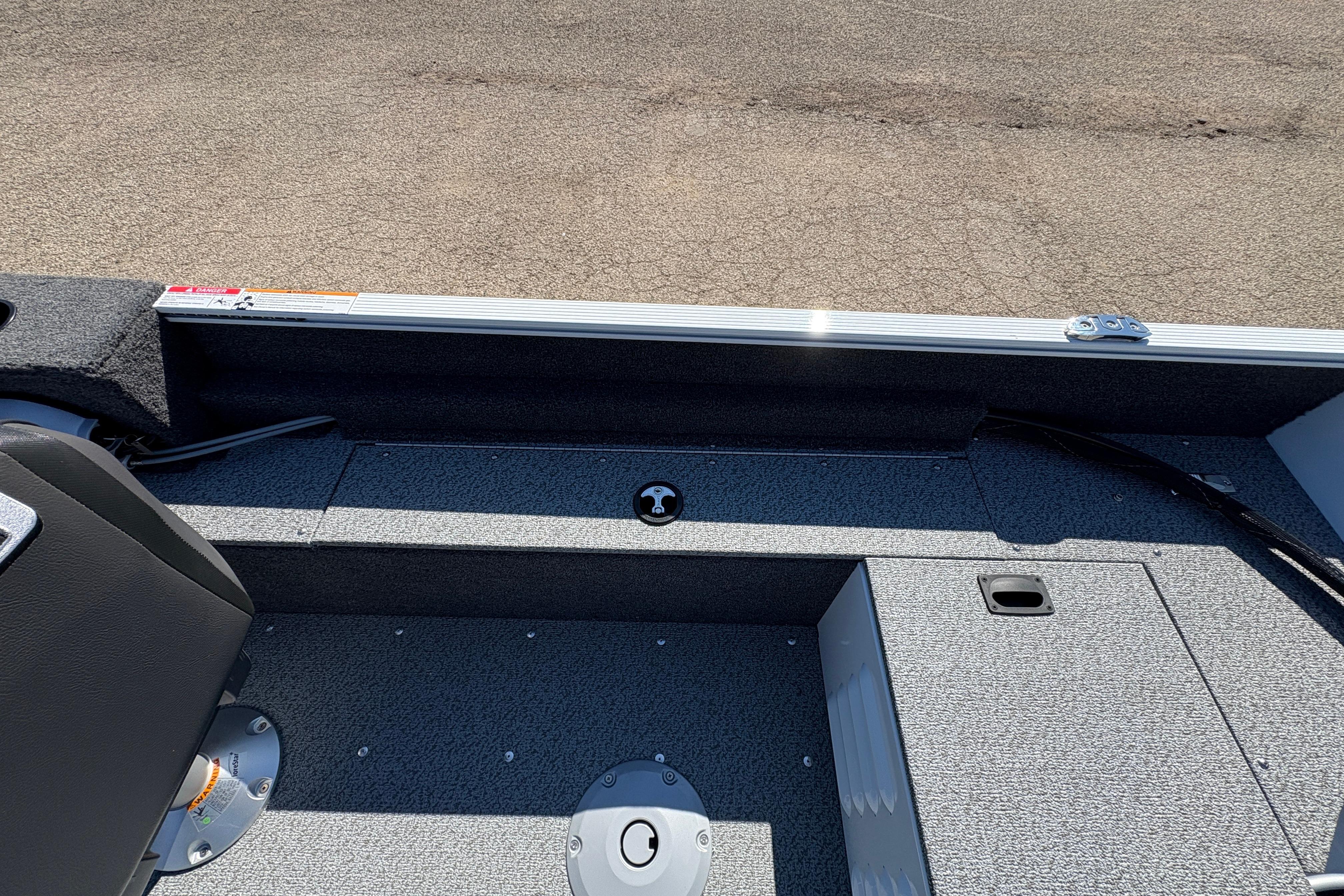 2026 Lund 1650 Angler SS boat interior with seating and storage compartments.
