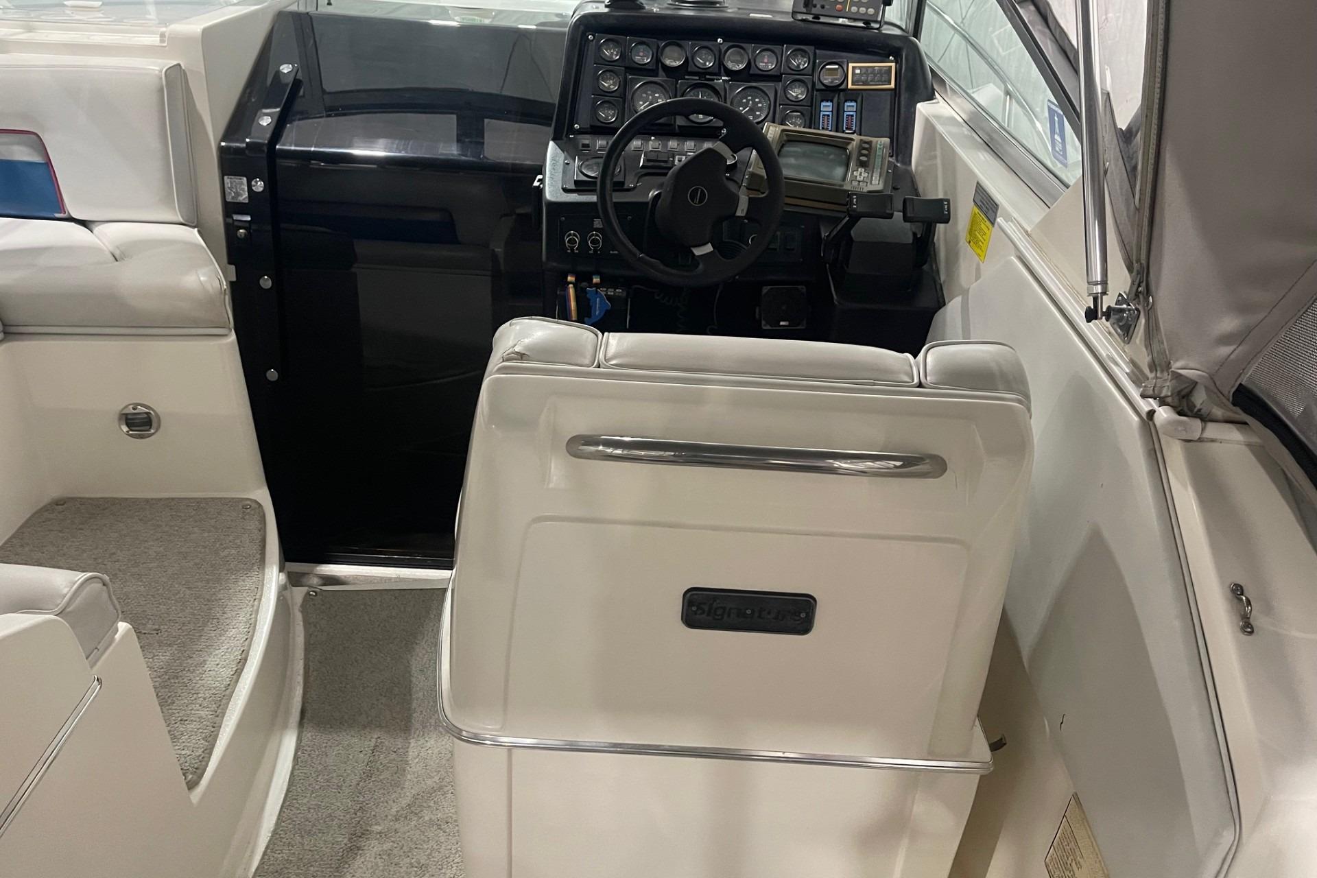 1992 Chaparral Signature 30 boat interior with steering wheel and control panel.