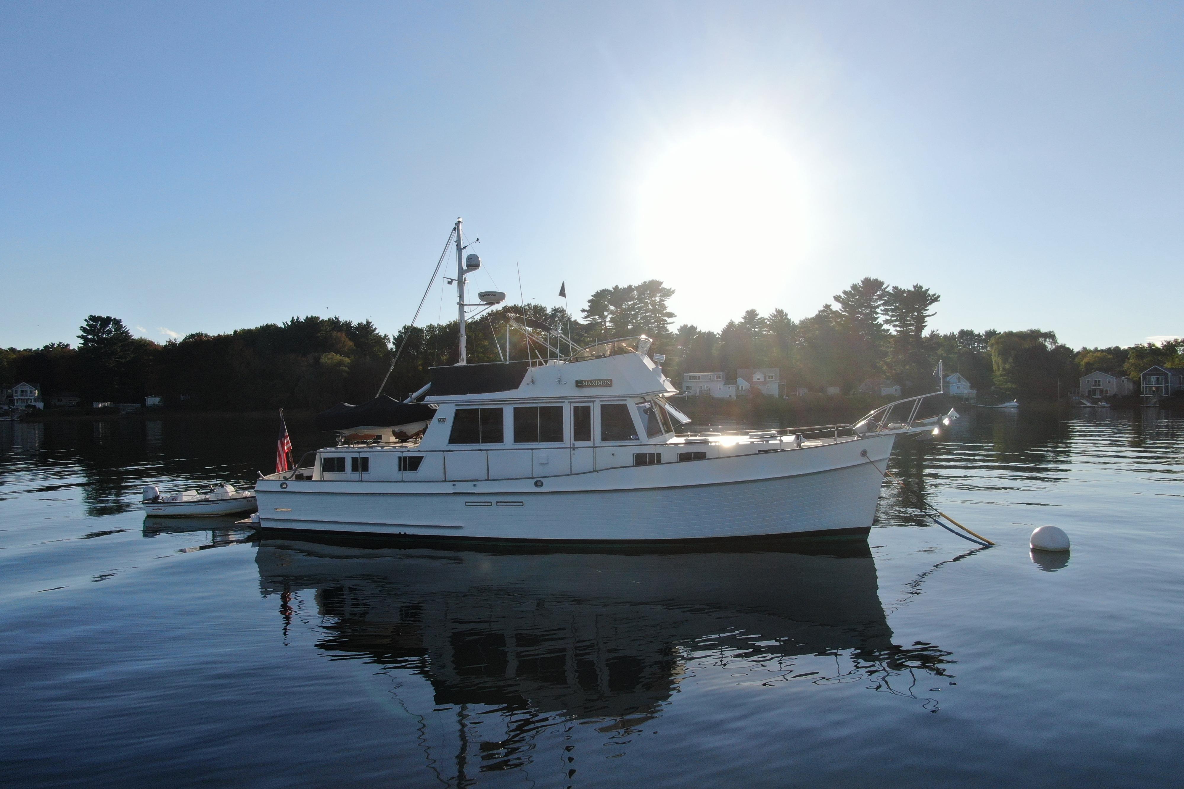 1989 Grand Banks 46 Classic yacht on calm water at sunset.