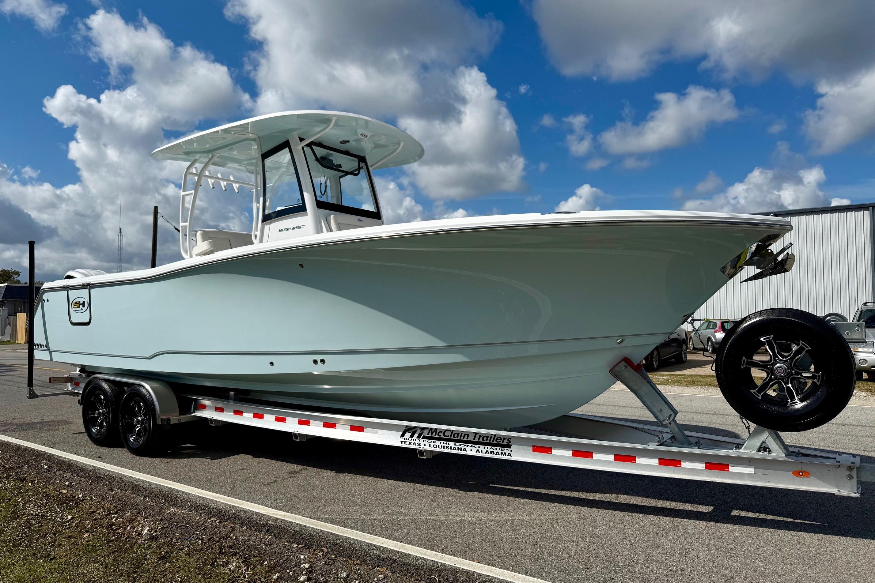 2026 Sea Hunt Ultra 285 Coffin Box boat on trailer under a cloudy sky.