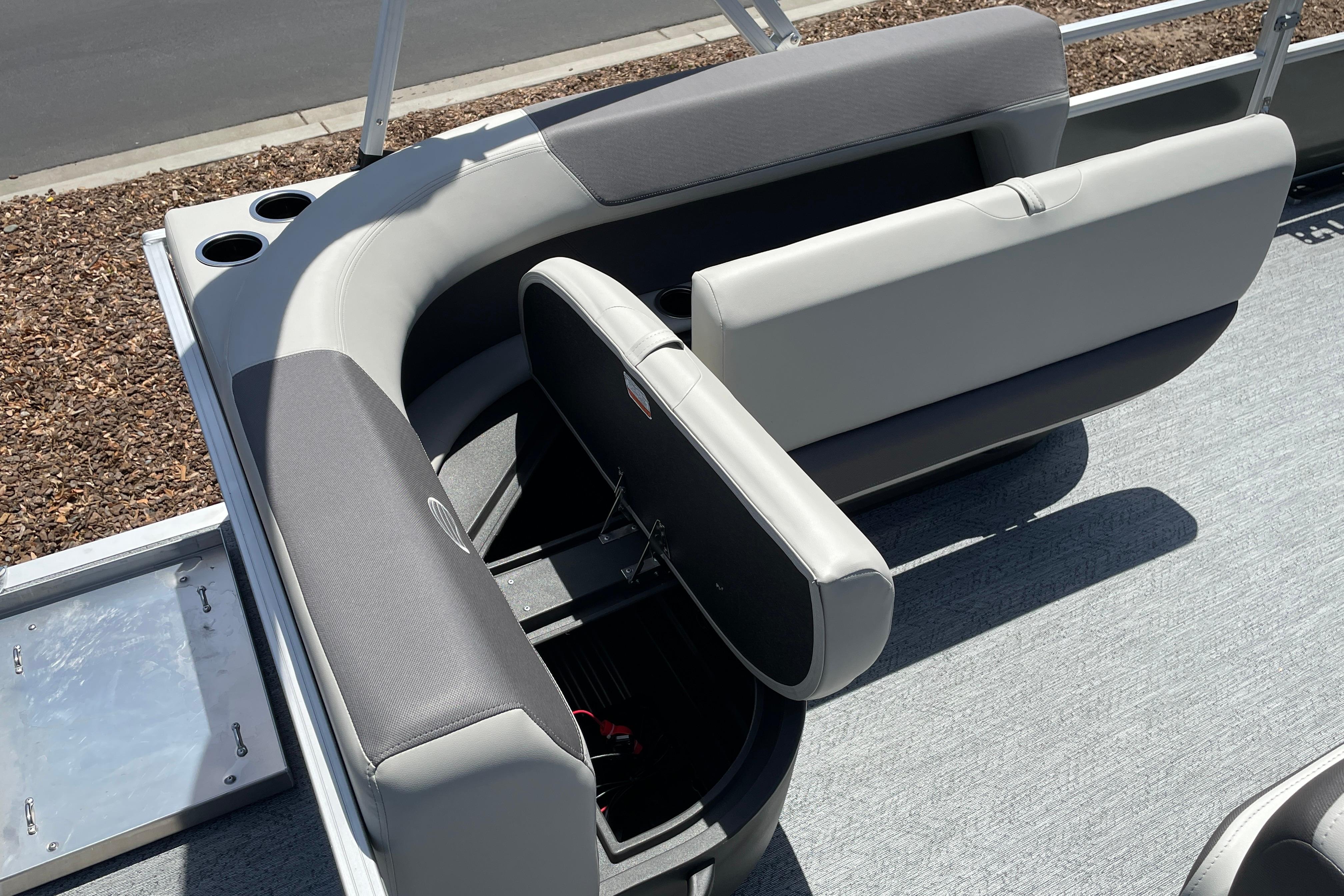 2026 Sun Tracker Bass Buggy 16 XL Select pontoon boat seating and storage area.