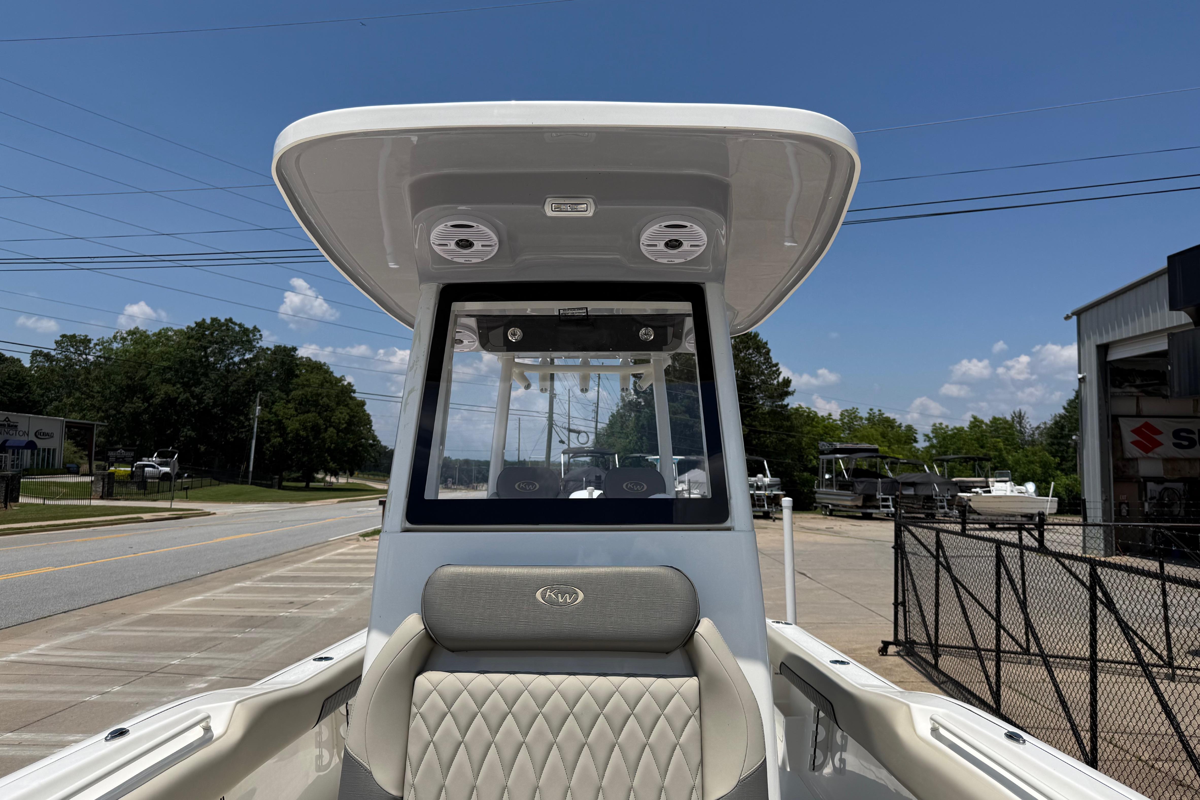 2027 Key West 249 FS boat with T-top and cushioned seating, parked outdoors.
