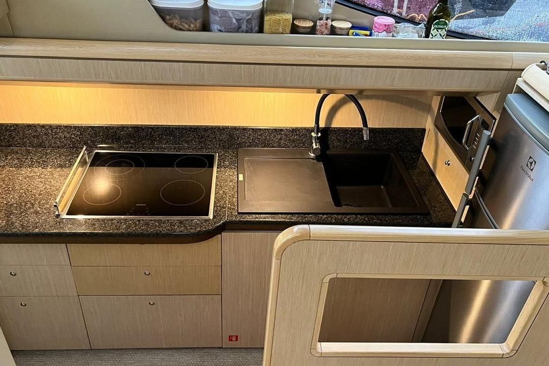 Modern kitchen in 2007 Ferretti 500 Elite yacht with stove, sink, and appliances.