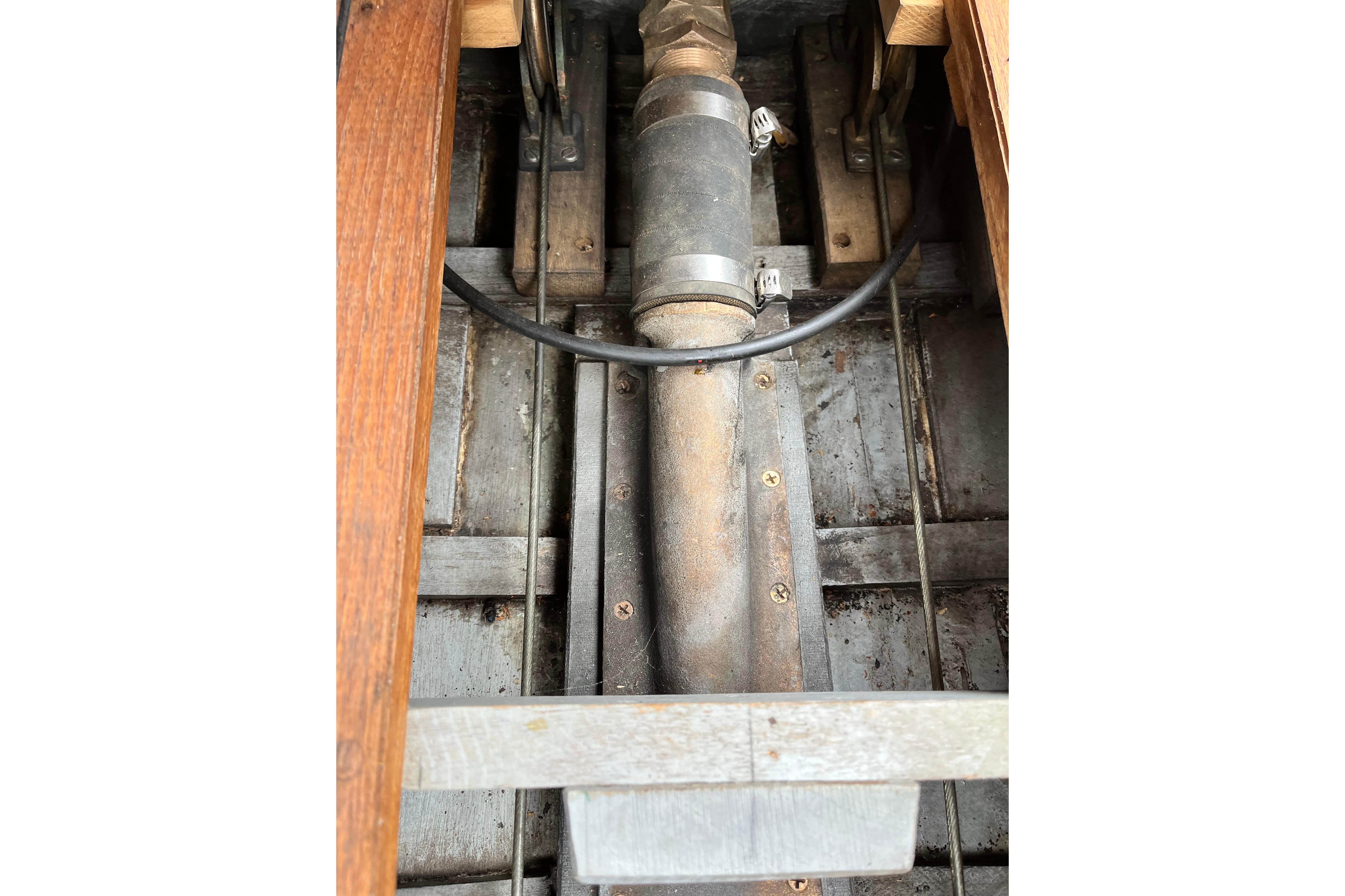 Close-up of 1908 Outing launch engine component with wooden and metal elements.