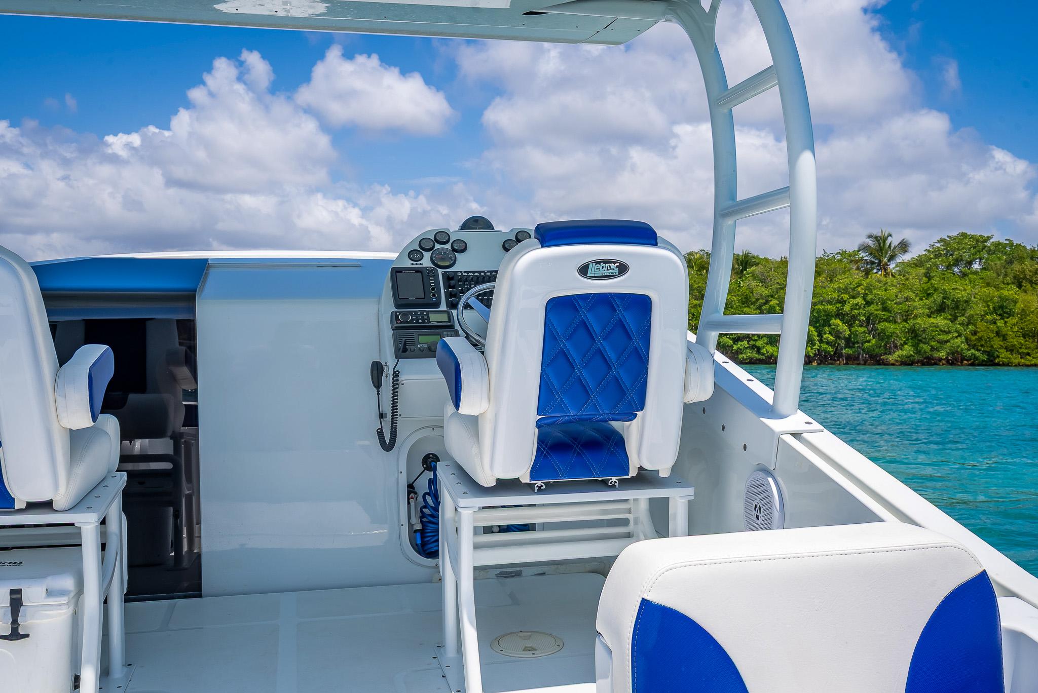 Nova 39 Sport 2020 boat interior with blue and white seating, steering console, and ocean view.