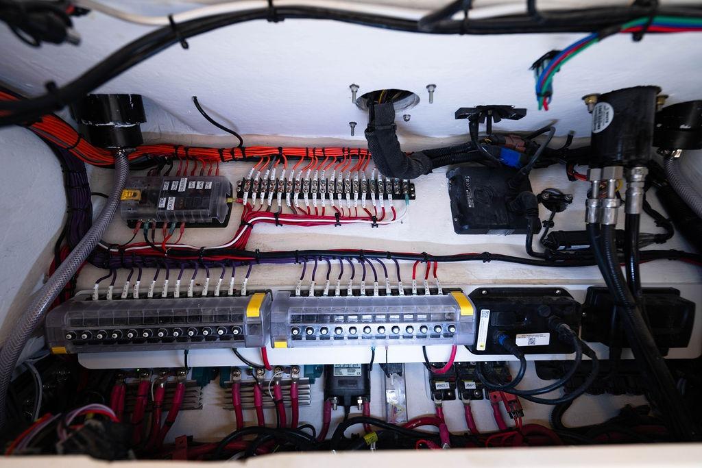 Electrical wiring system inside a 2027 Reef Runner 340 boat, showcasing organized cables and connectors.