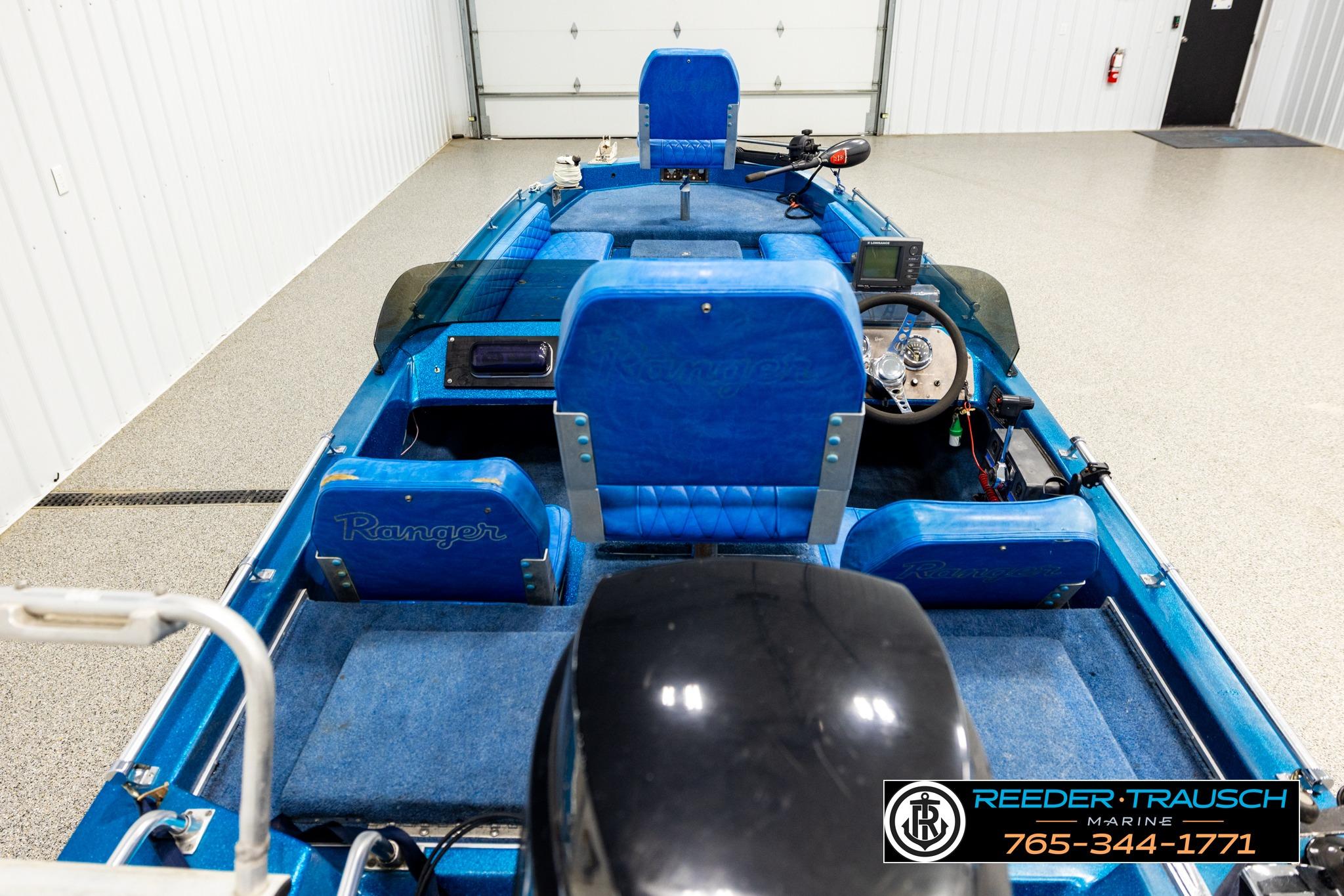 1980 Ranger 175 VS boat interior with blue seats and steering wheel in a garage.
