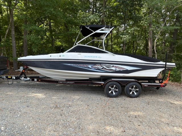 A 2007 Rinker 226 Captiva Bowrider on a trailer, surrounded by trees.
