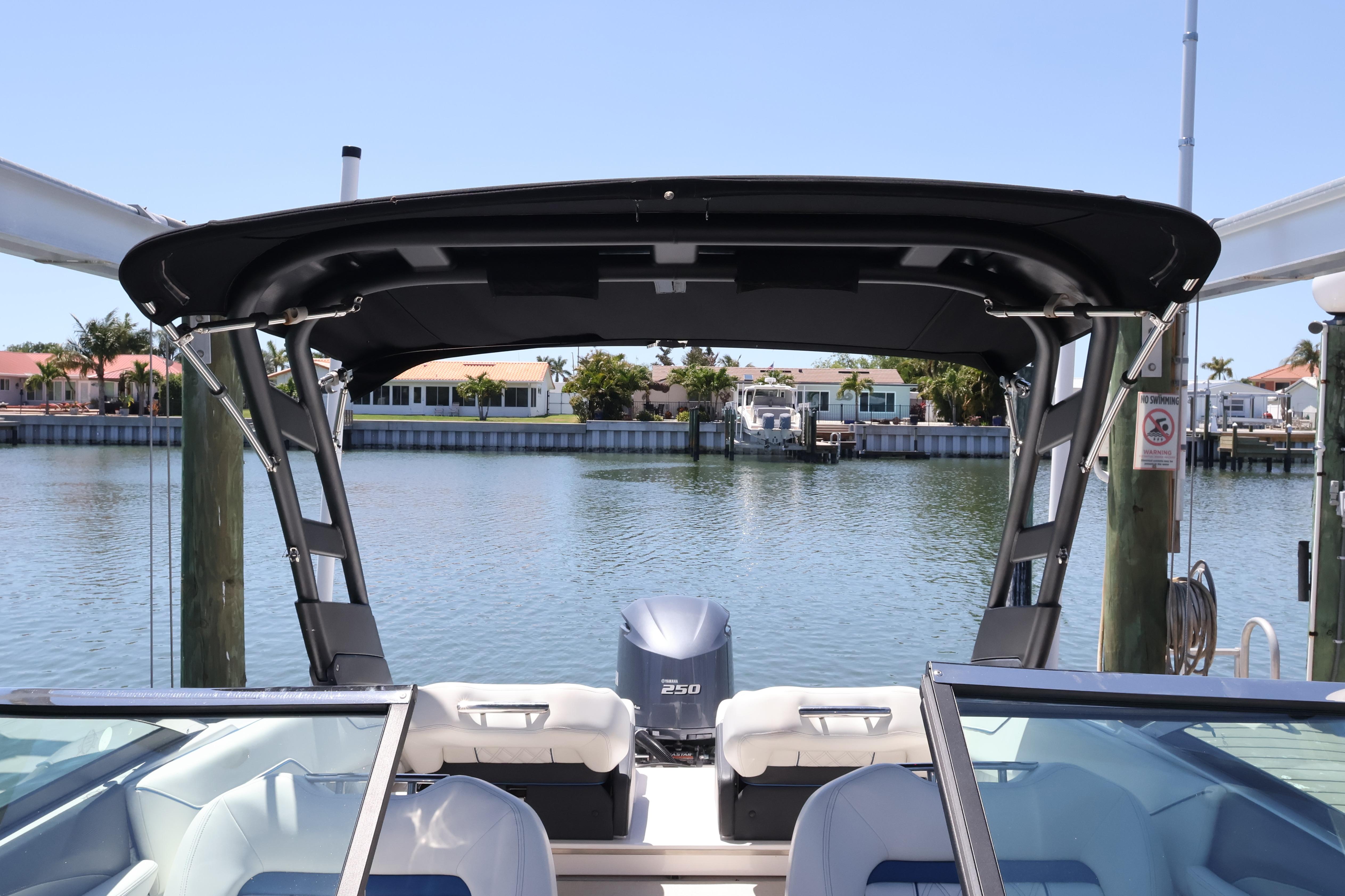 2020 Regal LX4 boat docked by waterfront homes, featuring a sleek design and powerful engine.