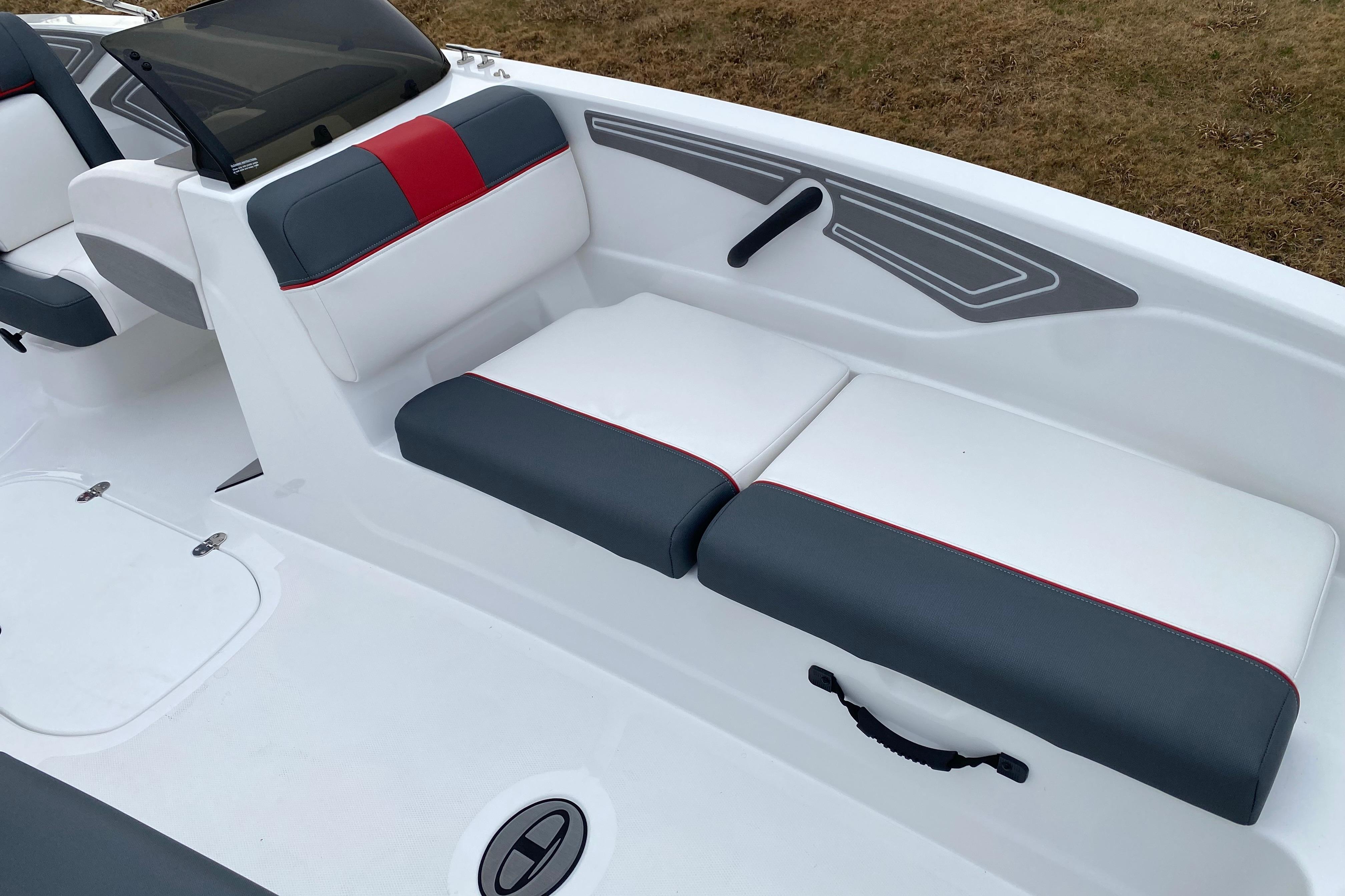 2026 Tahoe T21 boat interior with white and gray seating, red accents.