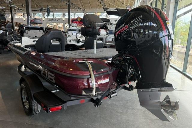 2026 Nitro Z18 boat with powerful engine, showcased in a showroom setting.