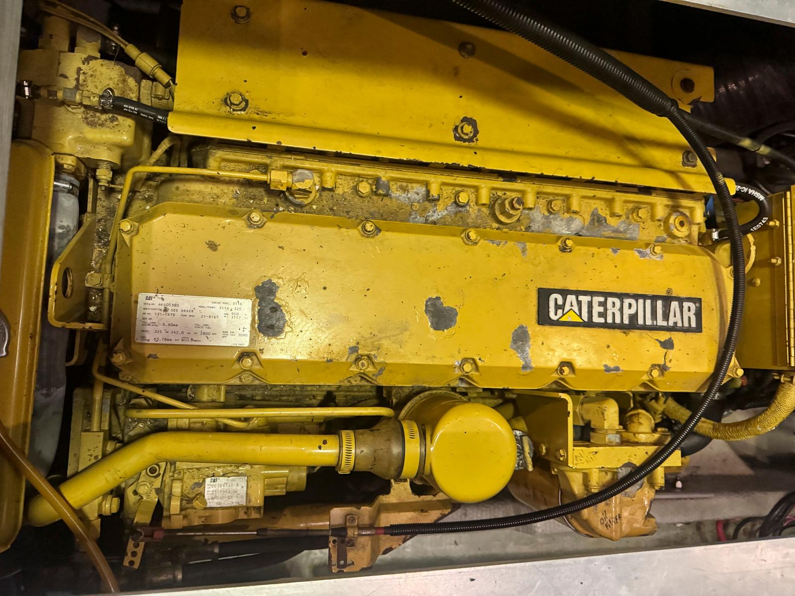 Caterpillar engine in a 1997 Mainship 350 Trawler, yellow and industrial.