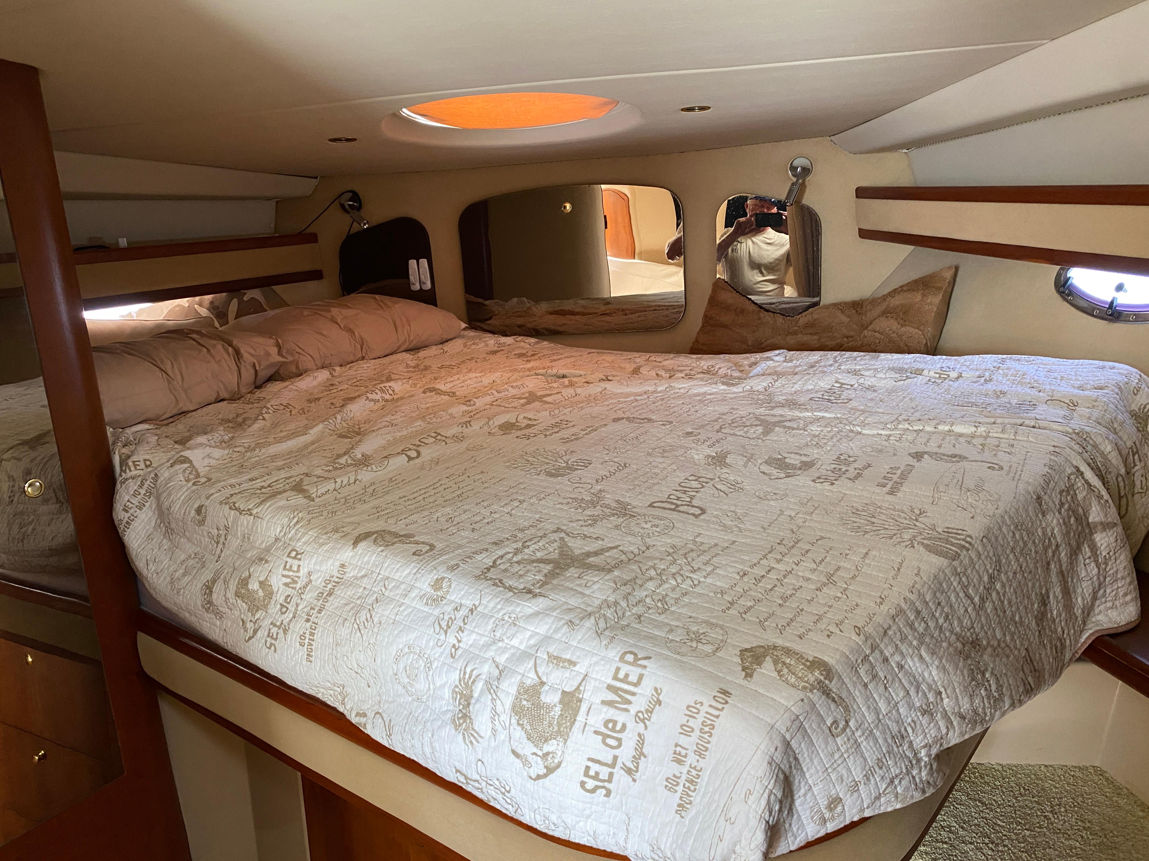 Luxurious cabin interior of 2000 Cruisers 3672 yacht with cozy bedding.