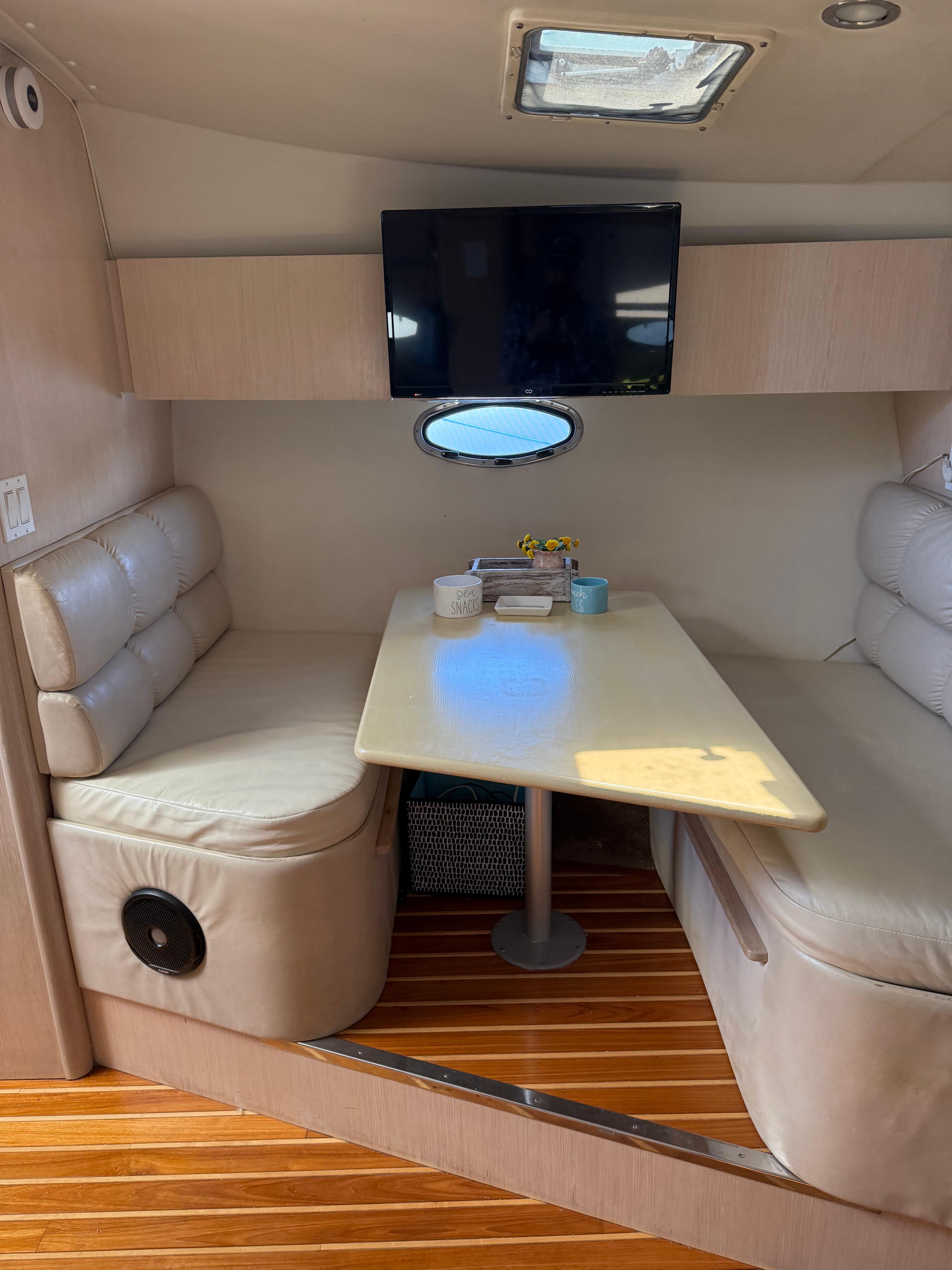 1996 Tiara Yachts 3500 Express interior with table and seating area.