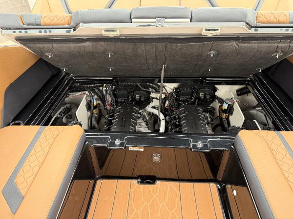 2025 Yamaha Boats 255XD engine compartment with dual engines and tan upholstery.