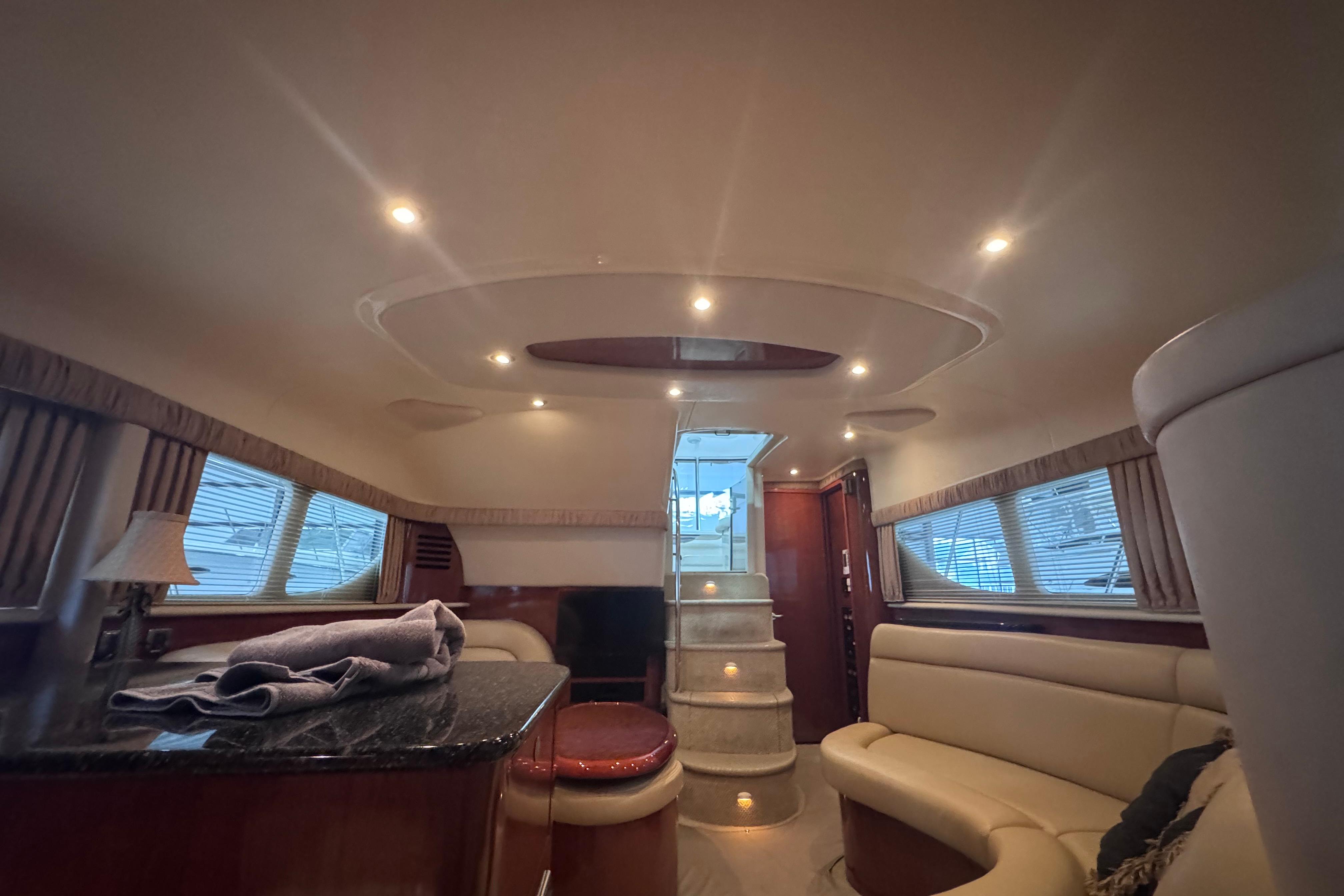 Luxurious interior of a 2004 Sea Ray 390 Motor Yacht with elegant seating and lighting.