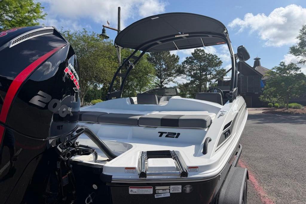 2026 Tahoe T21 boat with powerful 200 HP engine, parked outdoors under clear skies.