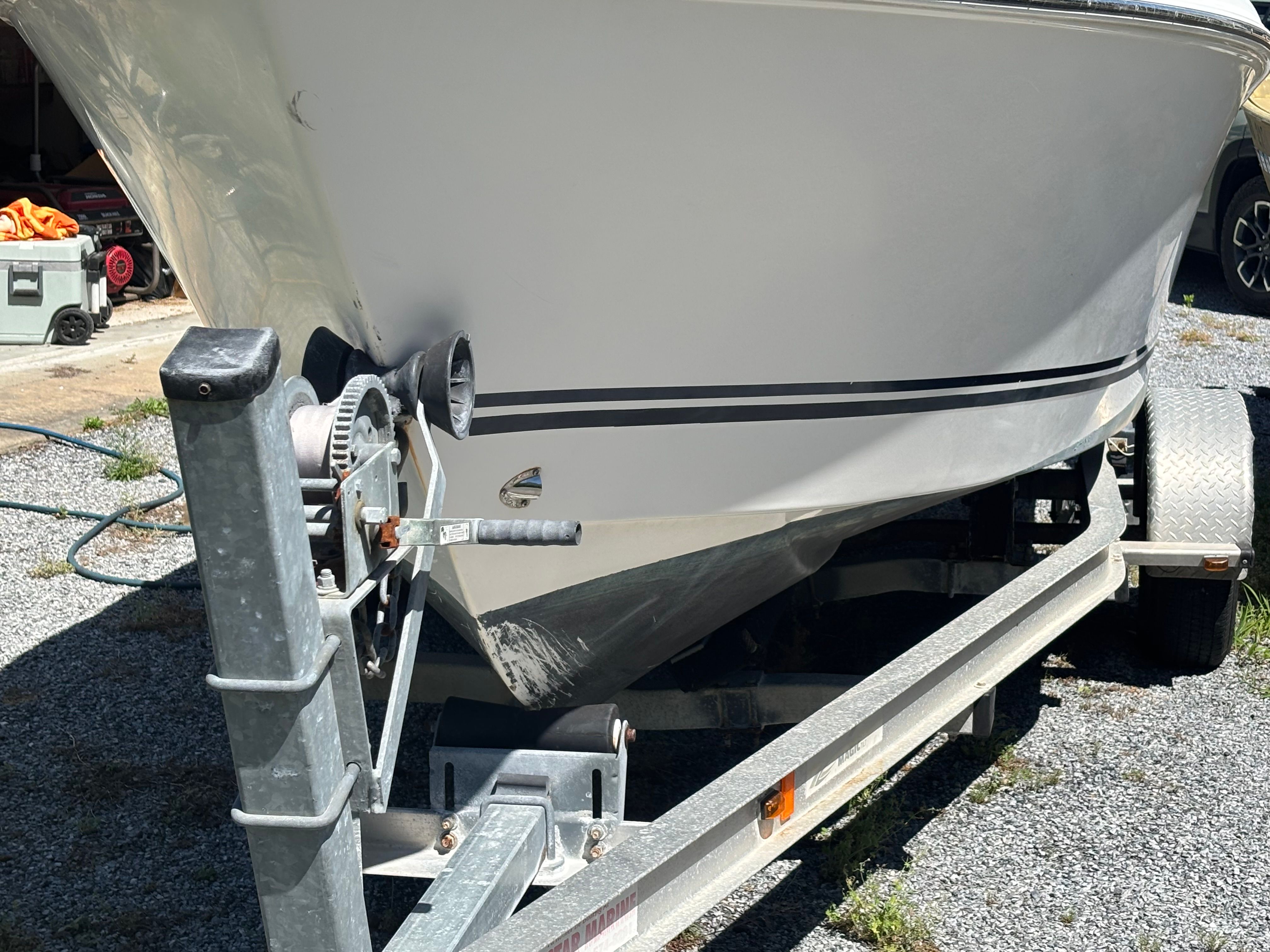 A boat on a trailer, ready for transport.