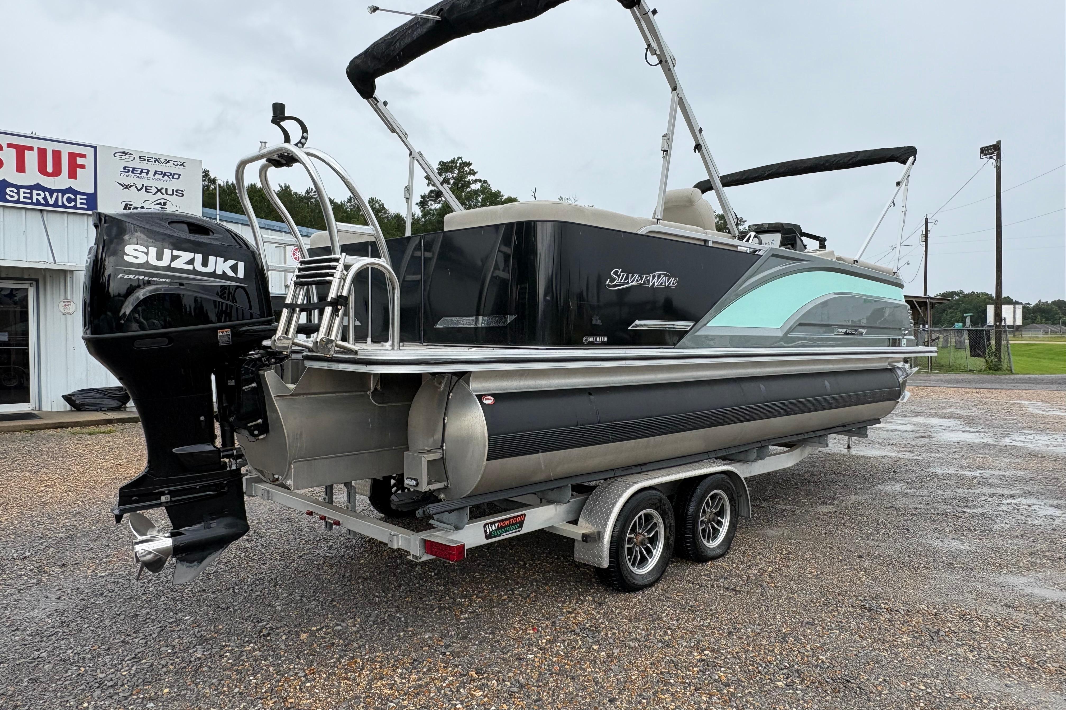 2023 SilverWave 2410 CLS pontoon boat with Suzuki outboard motor on a trailer.